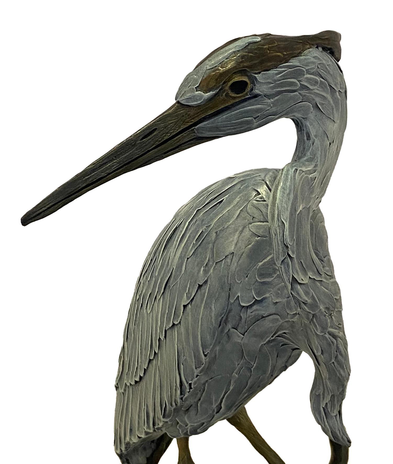 Bronze poly chromed Heron Sculptured by artist Geoffrey Smith. This was an edition of 48 and was listed on the artist price list dated July 1st 1999 for $6,800.  The bronze sculpture measures approximately 38 inches high with 16 inch diameter. From