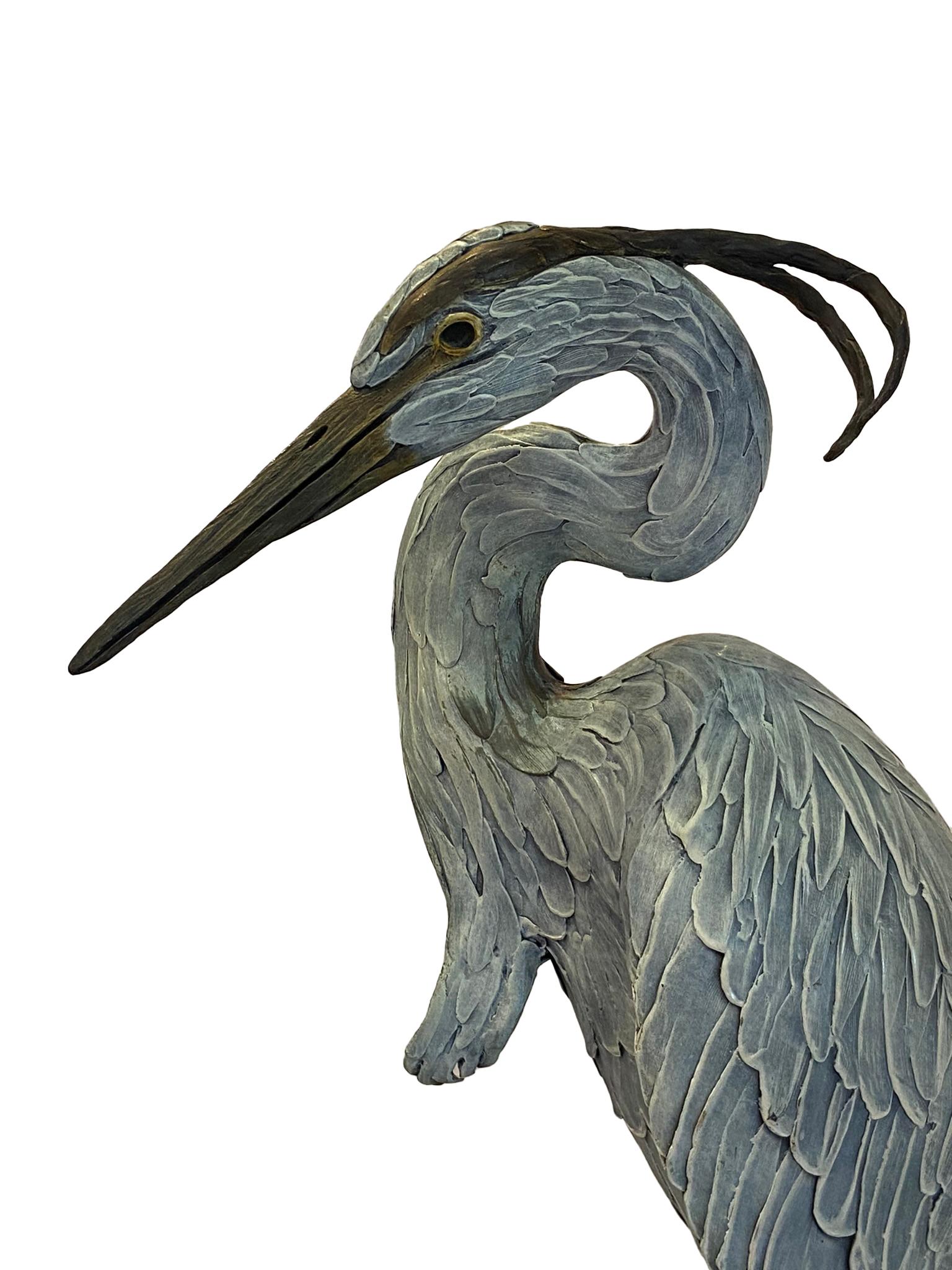 Bronze poly chromed Heron Sculptured by artist Geoffrey Smith. This was an edition of 48 and was listed on the artist price list dated July 1st 1999 for $7,800.  The bronze sculpture measures approximately 55 inches high with 16 inch diameter. From