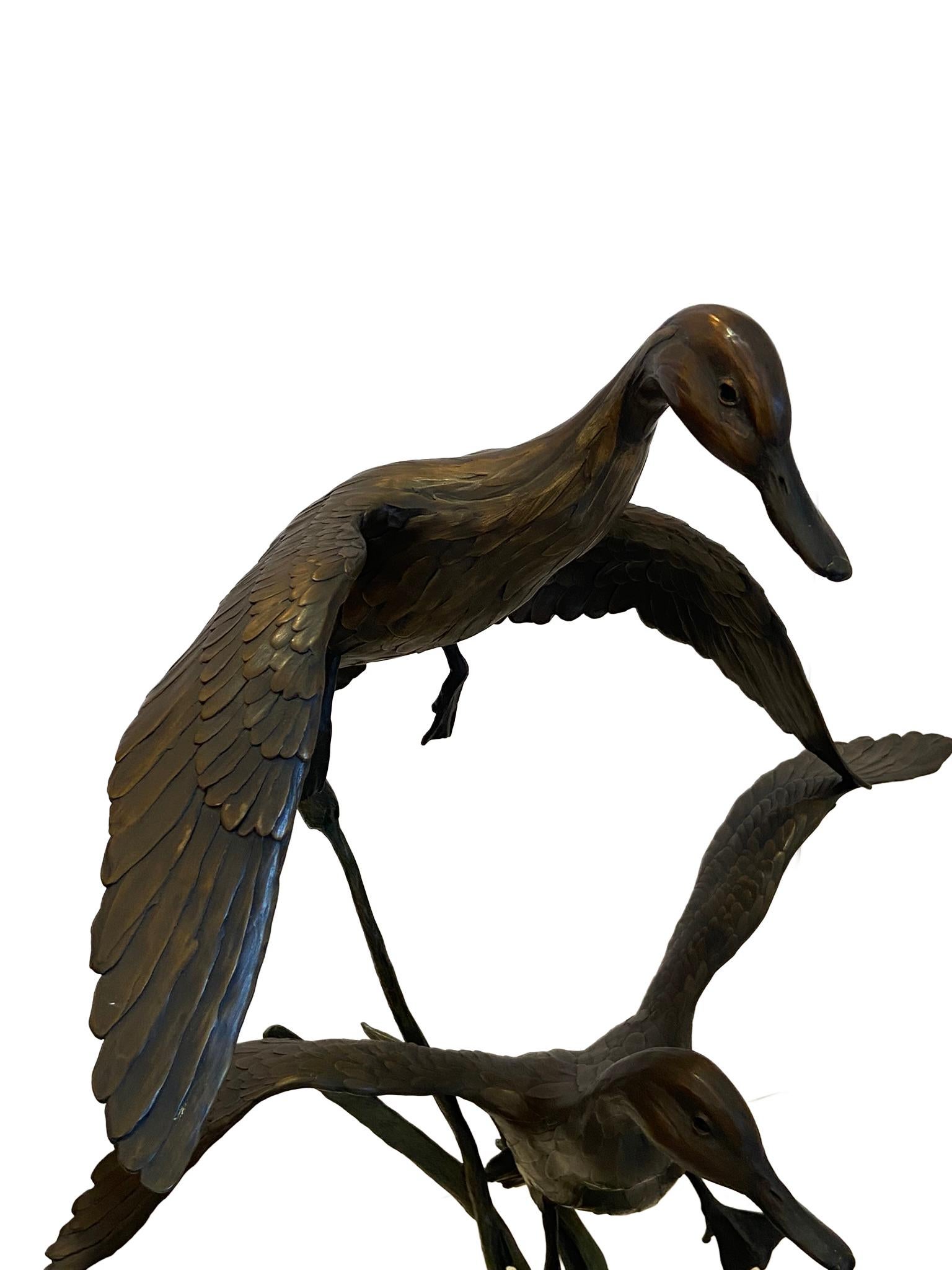 Bronze pair Pintail Ducks Sculptured by artist Geoffrey Smith. This was an edition of 48 and was listed on the artist price list dated July 1st 1999 for $7,800.  The bronze sculpture measures approximately 46 inches high with 29 inch diameter. From