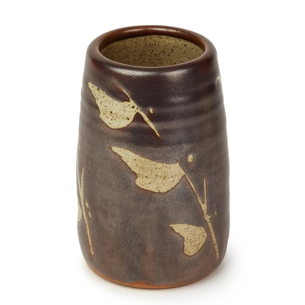 A very stylish and good sized studio pottery stoneware vase decorated in tenmoku glazes on a grey glazed ground with wax resist leafy twig like designs repeated around the body by renowned and highly sought after potter Geoffrey Whiting (English,