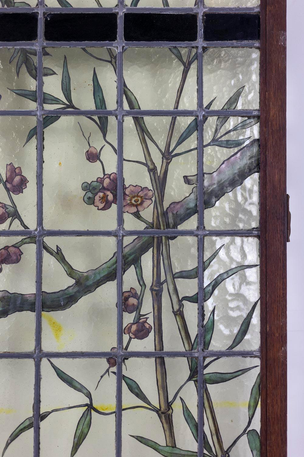 Geoffroy, signature. 

Pair of stained glass windows in float and bubbled glass, representing an animal on a ground in green tones, within reeds and lightly leafy branches. Frame in black lacquered metal.

French work realized in the nineteenth