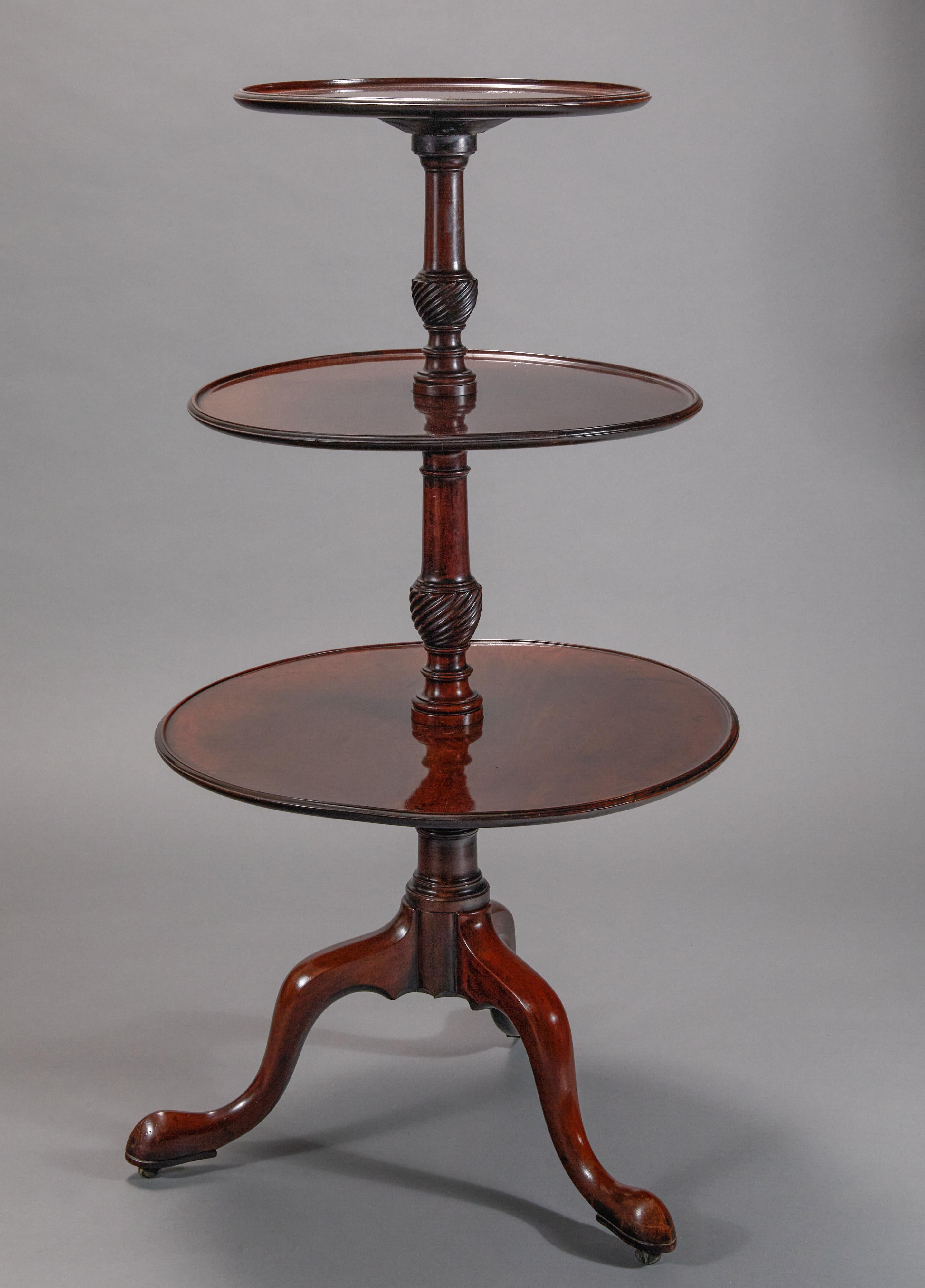 Elegant tripod legs with original castors.  Antique dumb waiters, sometimes referred to as buffets, were made to be used in a dining room for storing food that was about to be served. 