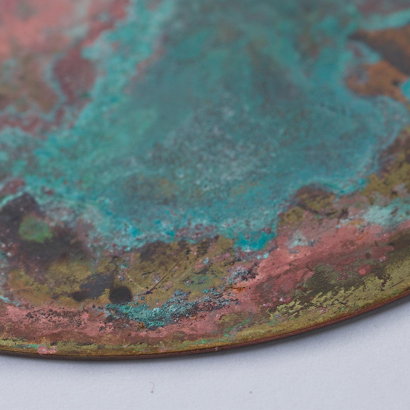 This set of six coasters is distinguished by a vibrant interplay of teal, burgundy, and green clouds accented with a dynamic corroded texture. Fashioned of brass, the pieces get handcrafted step by step, the treatment with acids and oxides lending