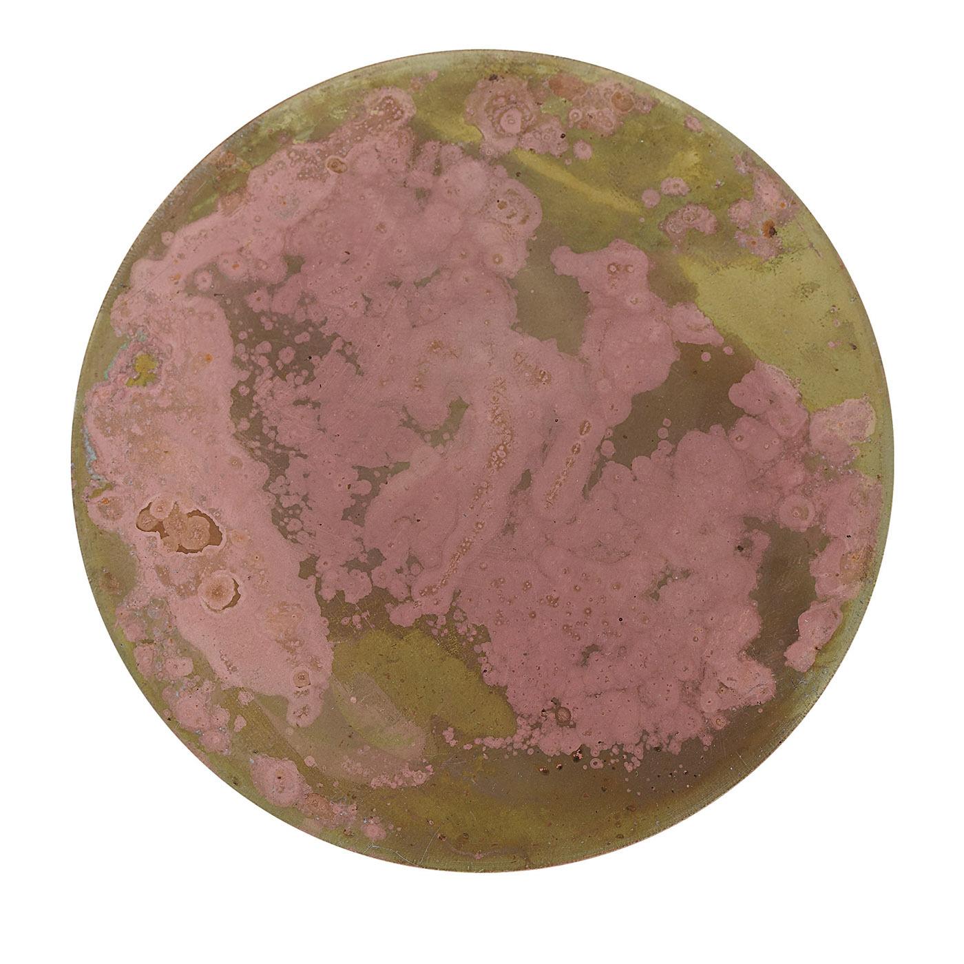 Six brass disks artfully treated with acids and oxides up to achieve their shaded green backdrop and mottled pink design make up this exclusive set of coasters. Covered with a velvety material for optimized grip and their front protected by multiple
