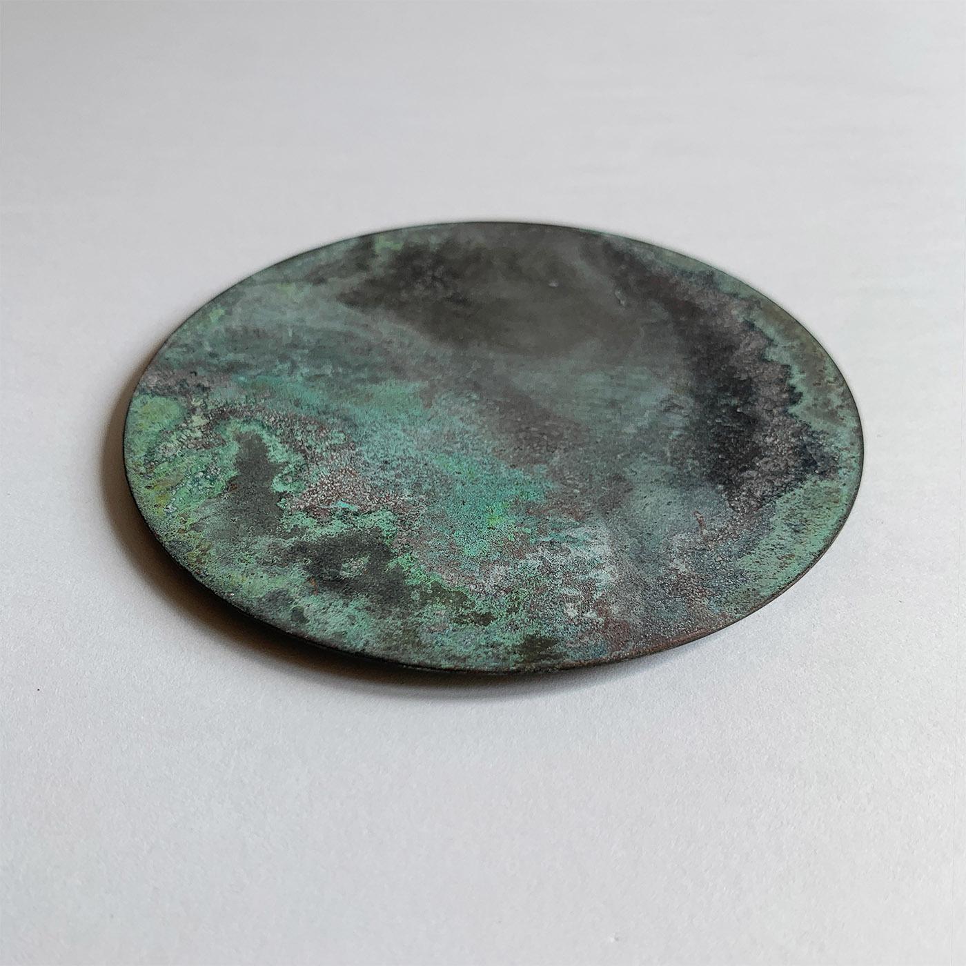 Treated with acids and oxides to achieve their distinctive corroded texture and unpredictable blue hues and traceries, the six brass coasters composing this set are craftsmanship gems of timeless allure. Their back is covered with a velvety material