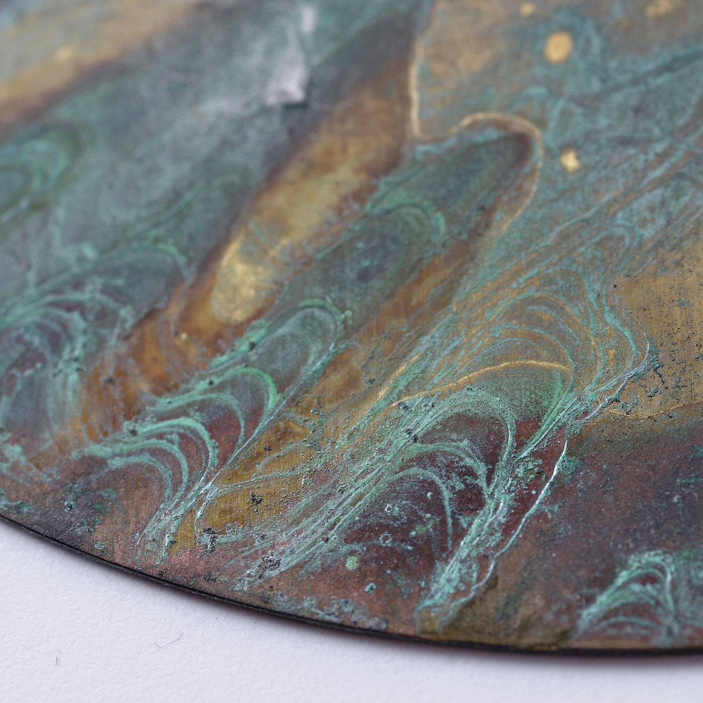 A splendid set of six handcrafted brass coasters where stunning gradients of blue, teal, beige, and burgundy coexist in a galaxy-like design traced by the interaction of the material with oxides. Each coaster is unique in its aesthetic and features