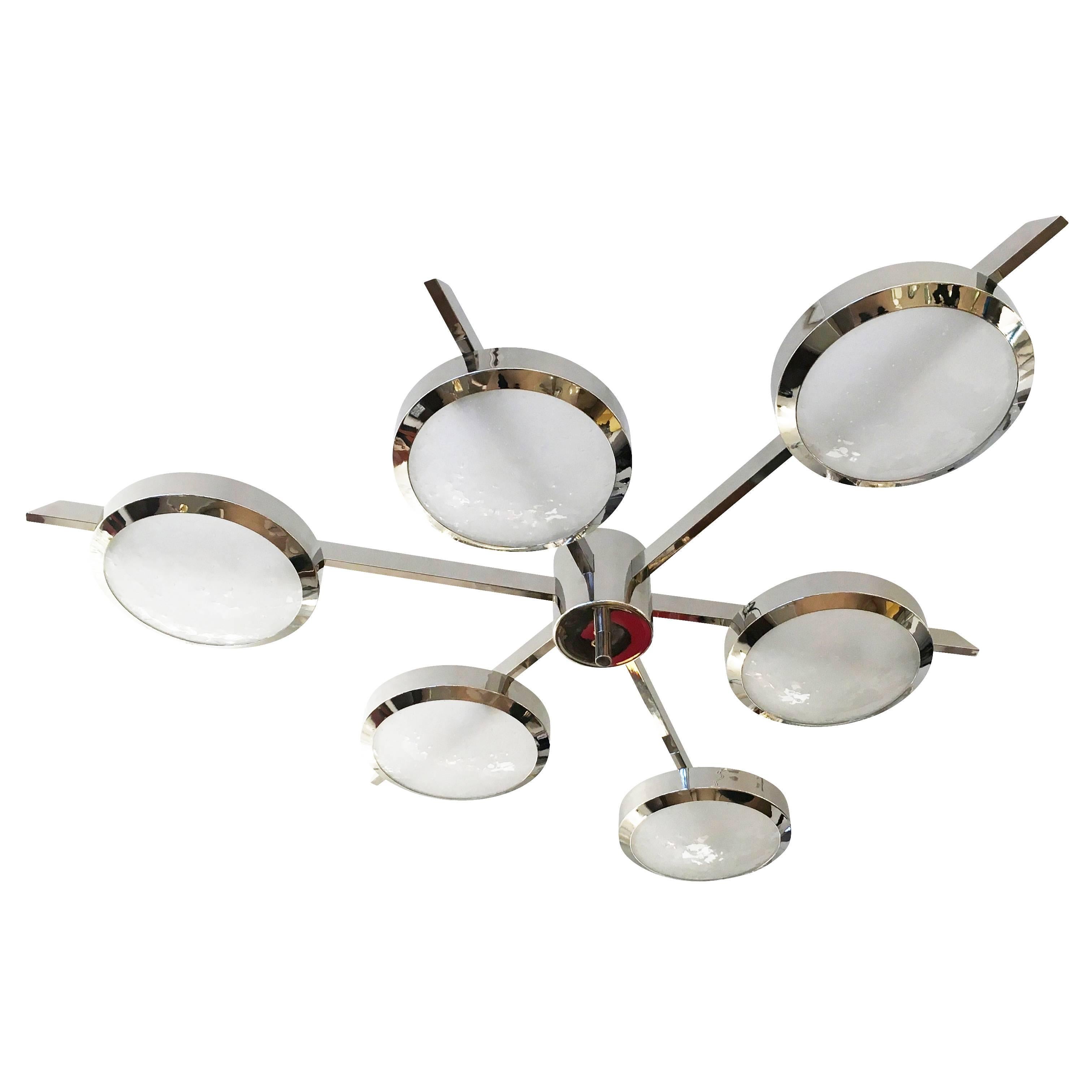 The Sei ceiling light is characterized by its star shaped frame with six suspended Murano glass shades. Shown as a flush mount in the nickel finish with our signature Murano bubble glass. Listed price is for the stock model in polished