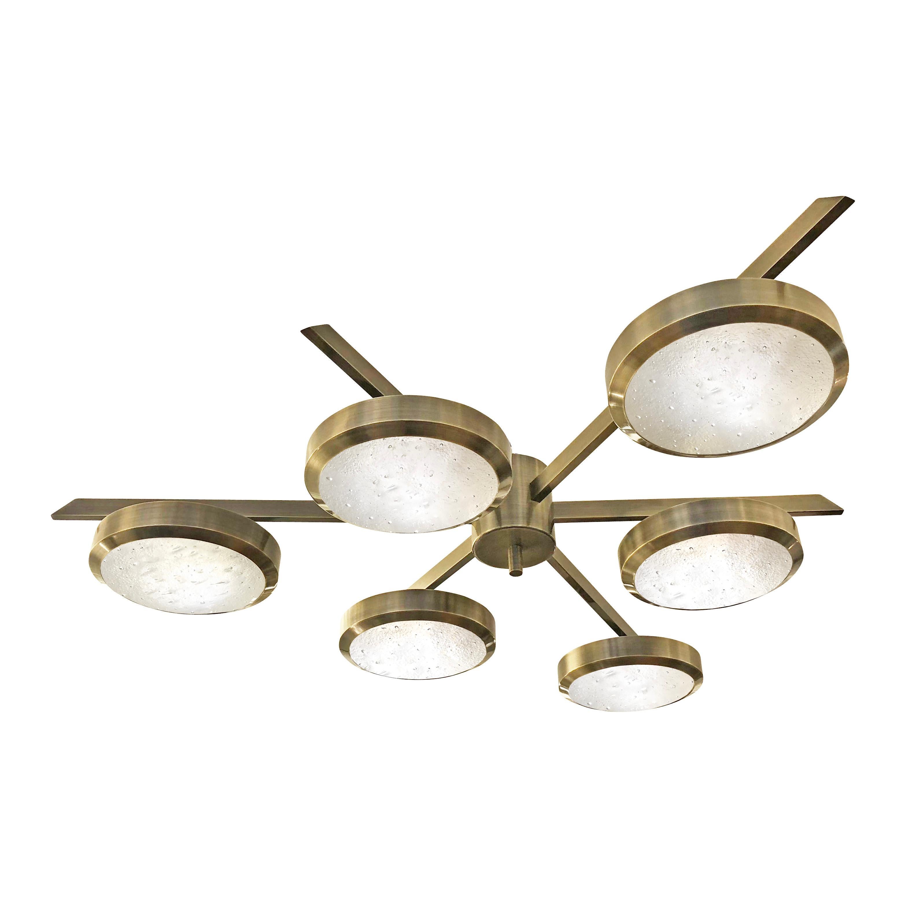 The Sei ceiling light is characterized by its star shaped frame with six suspended Murano glass shades. Shown as a flush mount in the bronzo ottone finish with our signature Murano bubble glass. Starting from $13,500.00 for the stock model in
