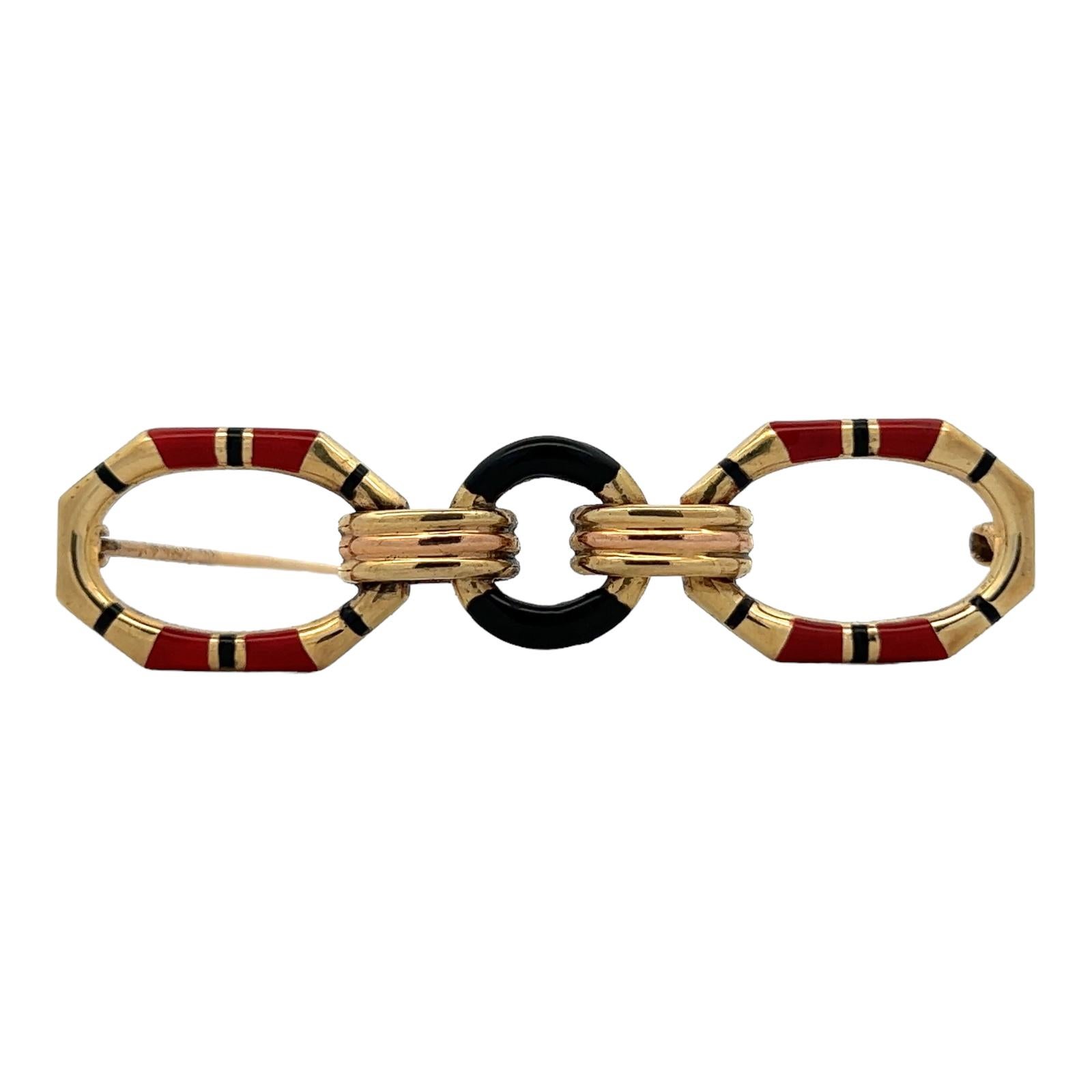 Geometric enamel brooch handcrafted in 14 karat yellow gold. The chic mid-20th century brooch is sophisticated and features black and orange enamel contrasting with bright yellow gold . The pin measures 2.25 inches in length and .60 inches in width.