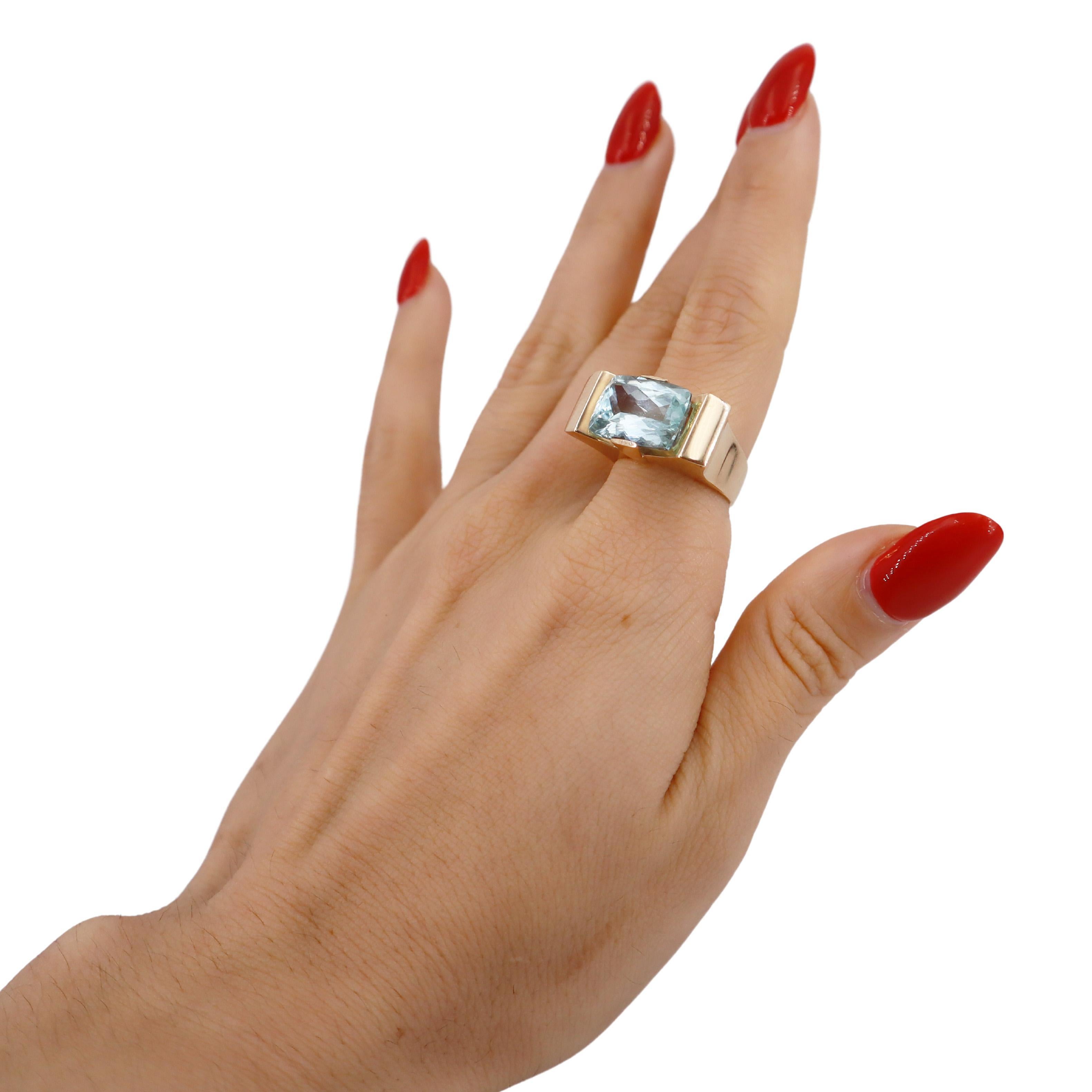 This striking geometric ring is crafted in 18k yellow gold, showcasing a stunning faceted Aquamarine that weighs approximately 6.50 carats. The ring's modern design features clean lines and bold angles, making it a standout piece that beautifully