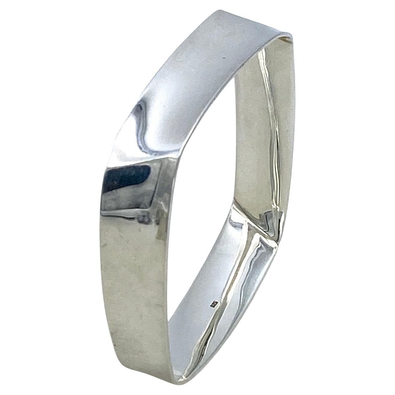This is a geometric solid sterling silver bangle. This 50 grams, polished bright silver square shaped bangle has a concave cross-section. You could have combinations with the other two of the geometric modern bangles on my separate listings and