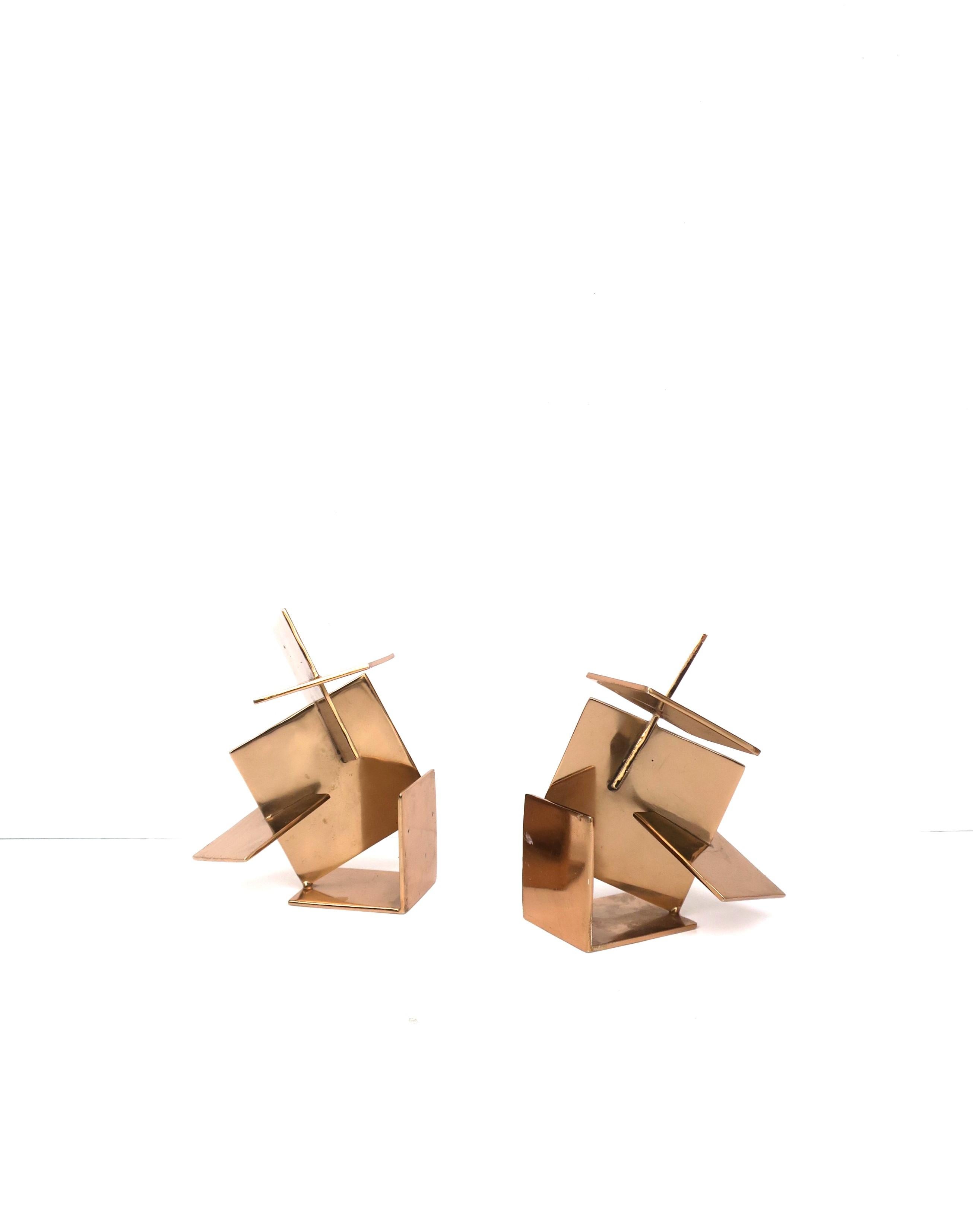 A substantial pair of metal bookends with a geometric abstract design and a copper-rose gold hue, in the Post-Modern Deconstructivist design style. Pair could work well as individual sculptures or as bookends, their indented use, as demonstrated in