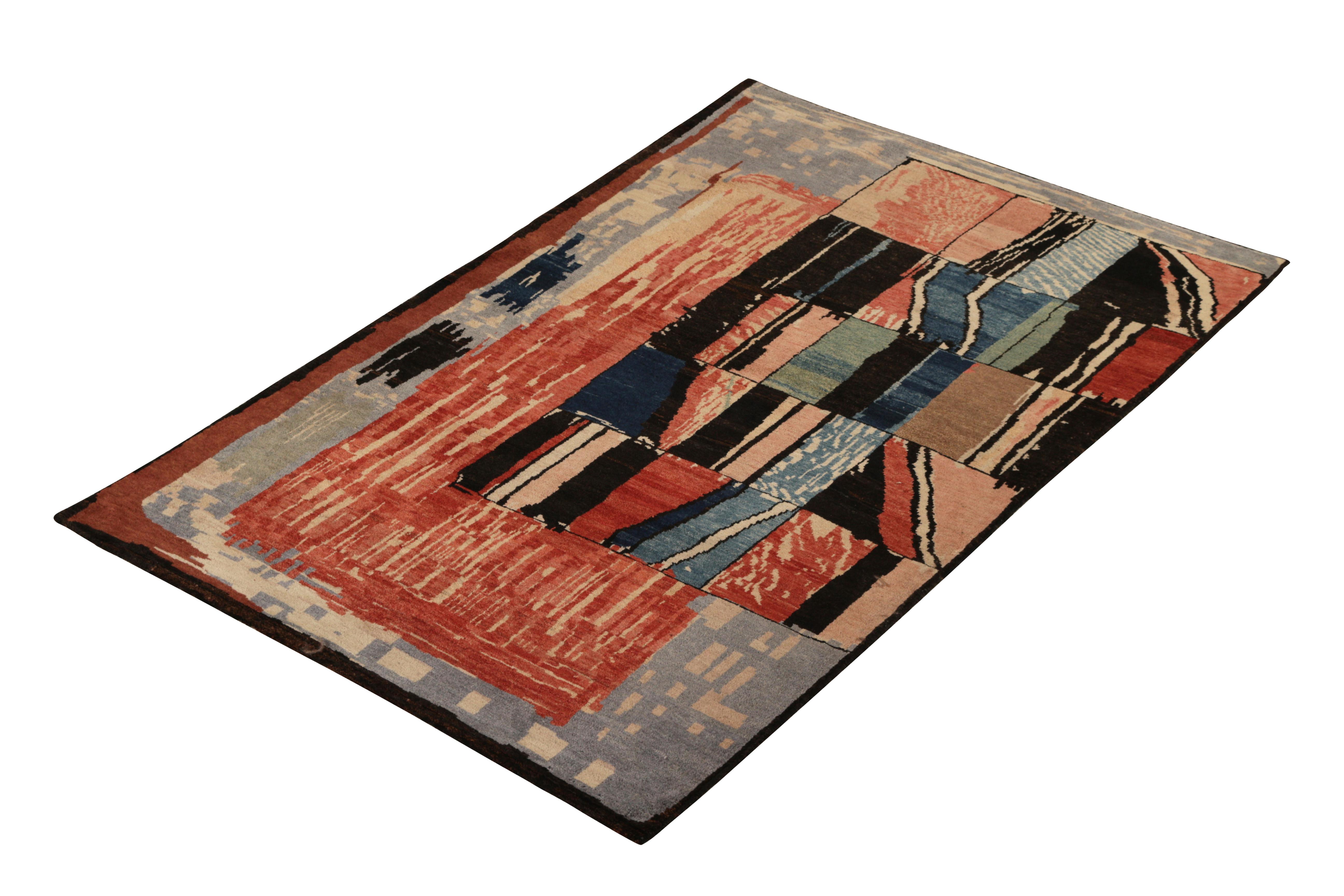 Hand knotted in wool originating from the works of Teddy Sumner circa 1990, this abstract rug employs an artisan approach to geometry with a striking play of red, blue, and multicolor accents ideal to the painterly graph and 4 x 6 rug scale. The
