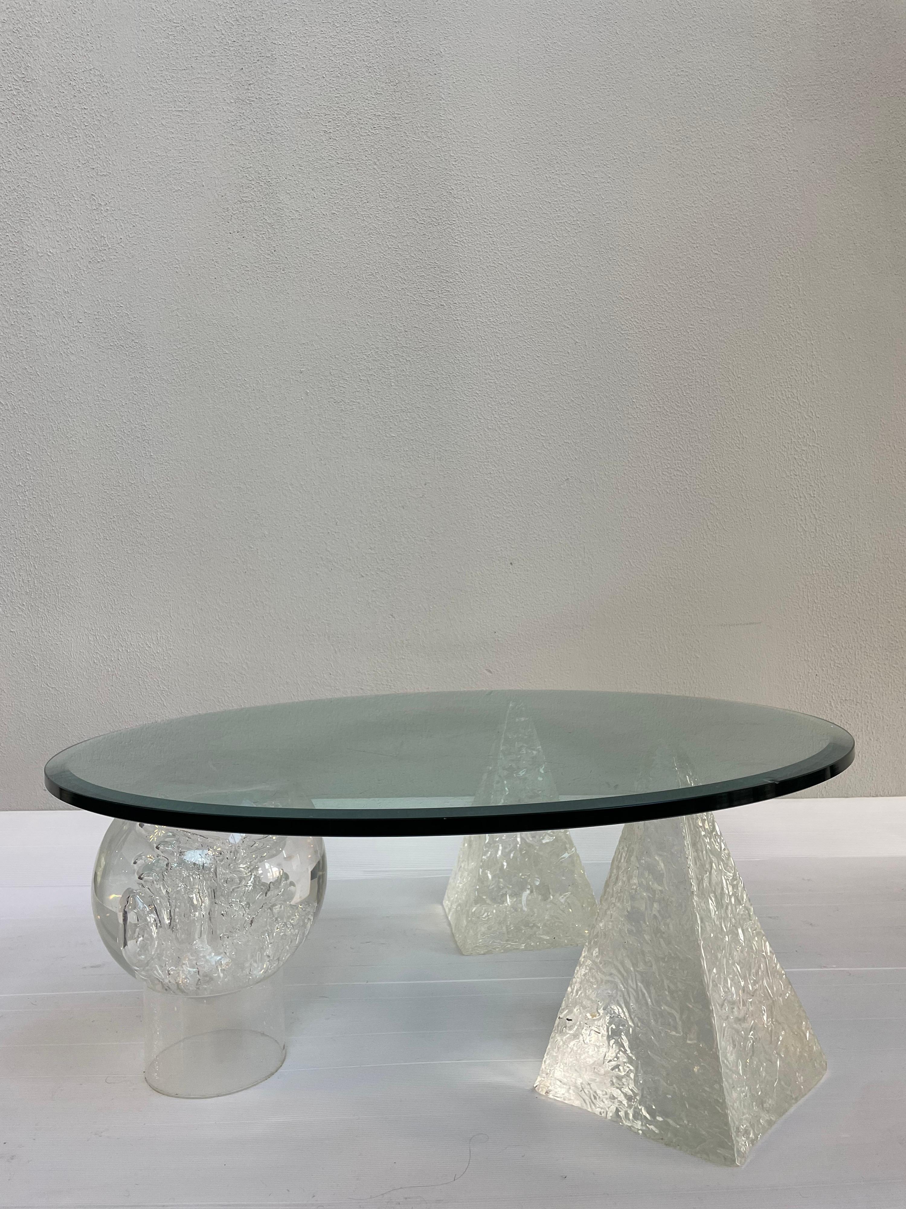 Vintage coffee table in the style of Massimo Vignelli. Round glass top and 3 geometric acrylic legs.