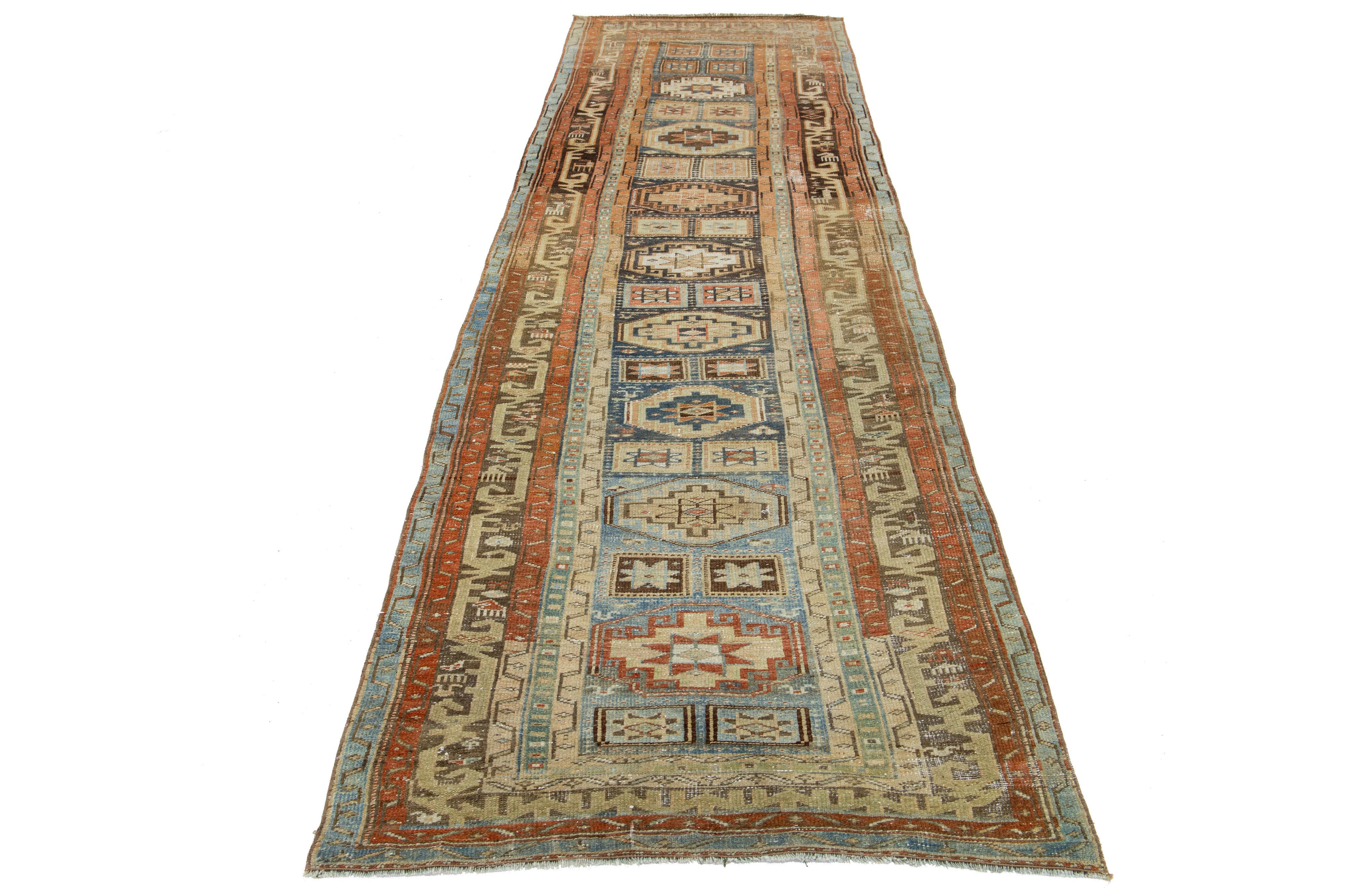 This beautiful 20th-century Heriz hand-knotted wool runner has a blue field. The piece features stunning orange and beige accents in a gorgeous geometric design.

This rug measures 3'7