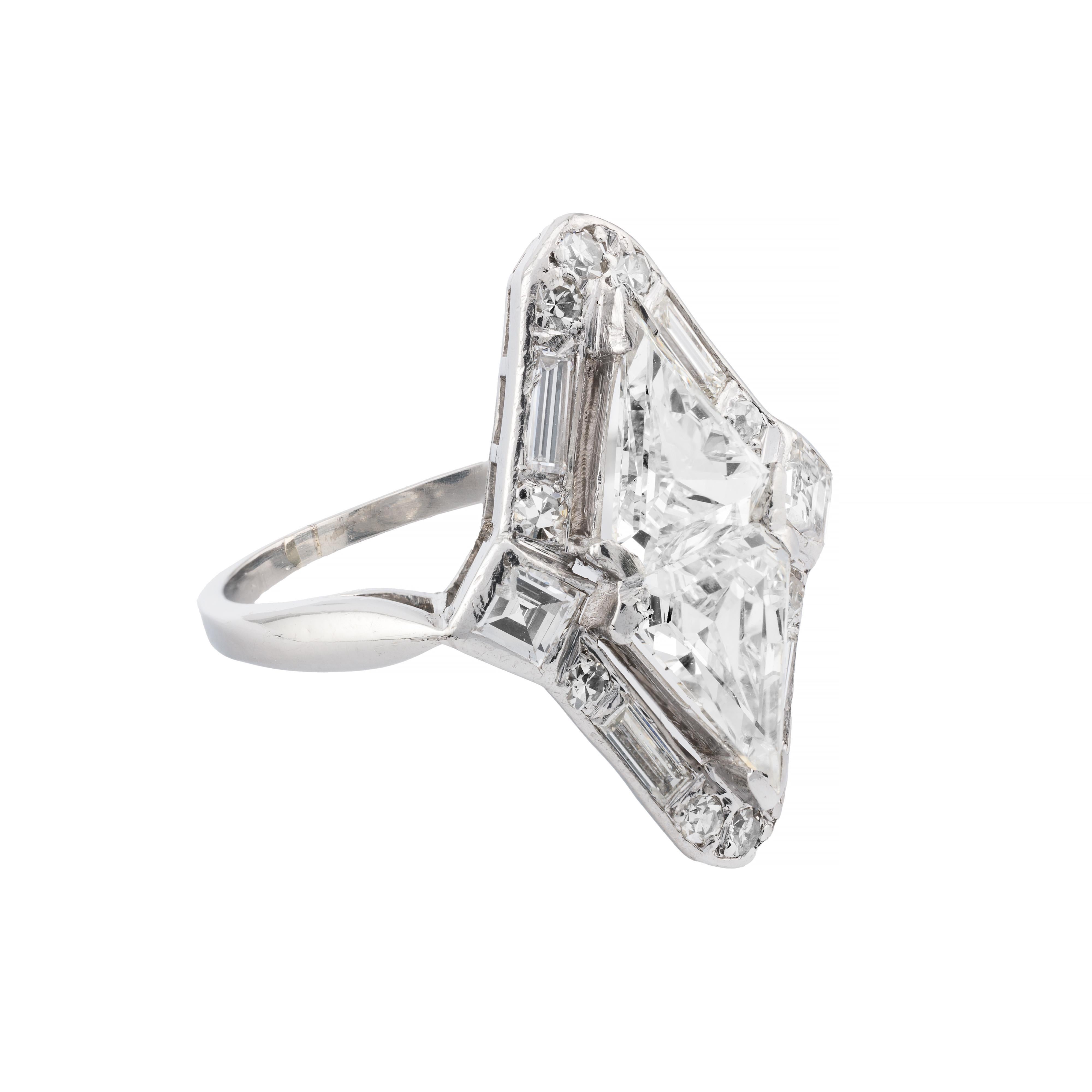 Aston Estate Jewelry Presents:

A striking statement ring featuring a pair of antique kite-cut diamonds, of 2.00 carats total weight, F color, VS1 clarity. Accented with an array of Asscher, Baguette, and early round cut diamonds totaling 1.06