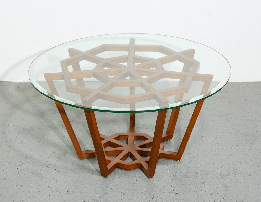 Vintage coffee table with geometric hardwood base and round glass top. Unsigned.