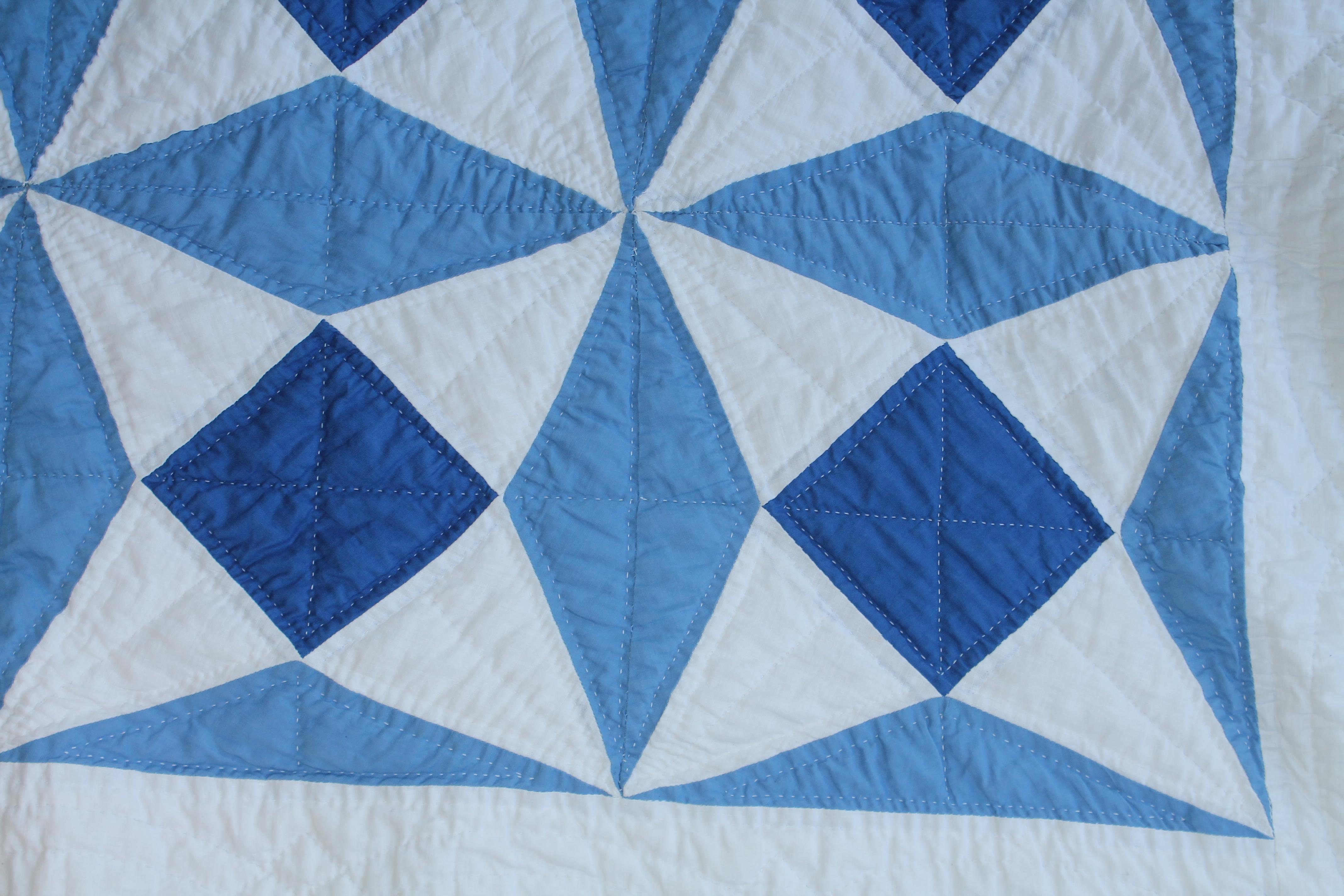 white quilt with blue stitching