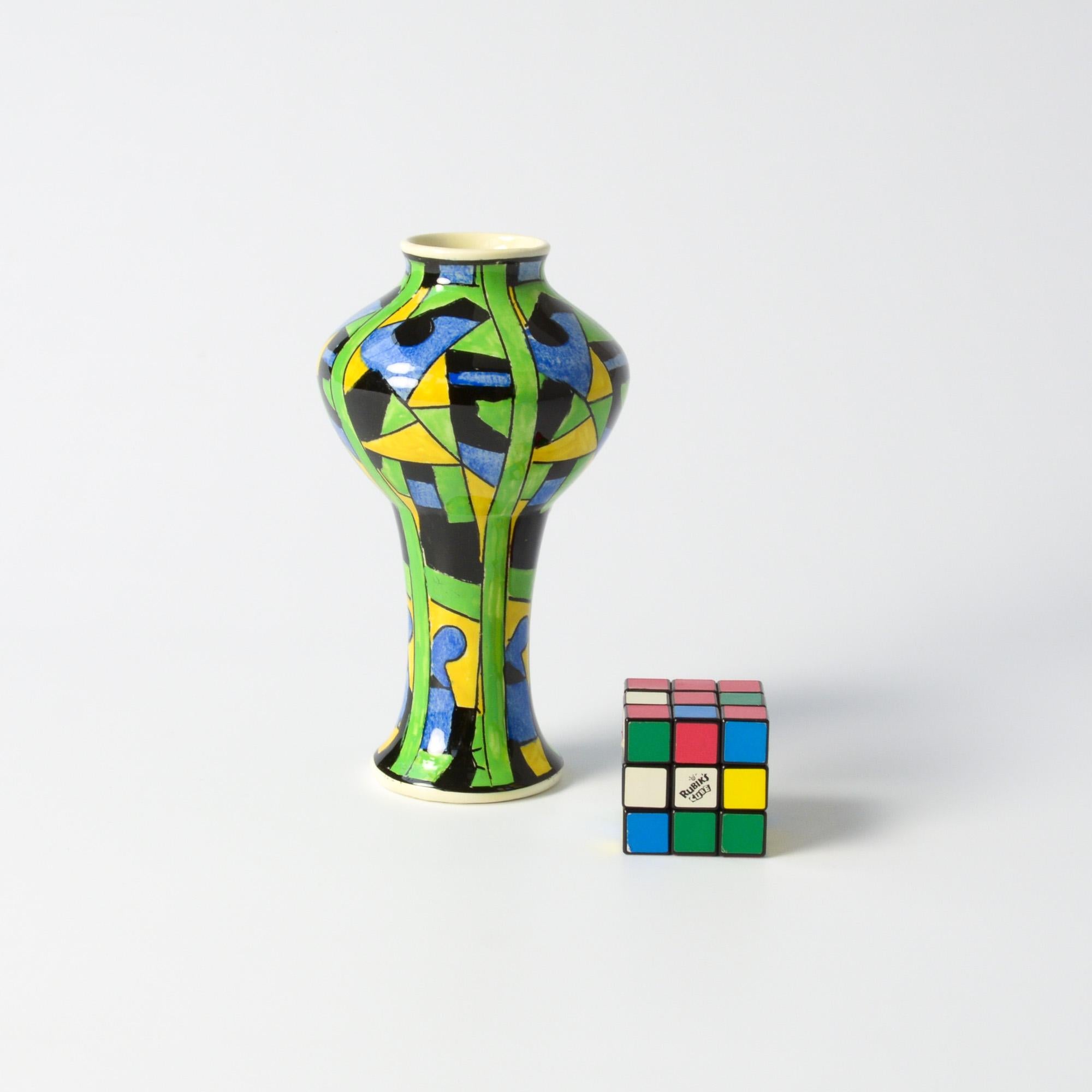 This polychrome vase was designed by Charles Catteau for Boch Freres.
The polychrome design with geometric patterns (D873) and the beautiful shape make this small vase extraordinary.
This Art Deco vase can be dated in 1924. It is in very good