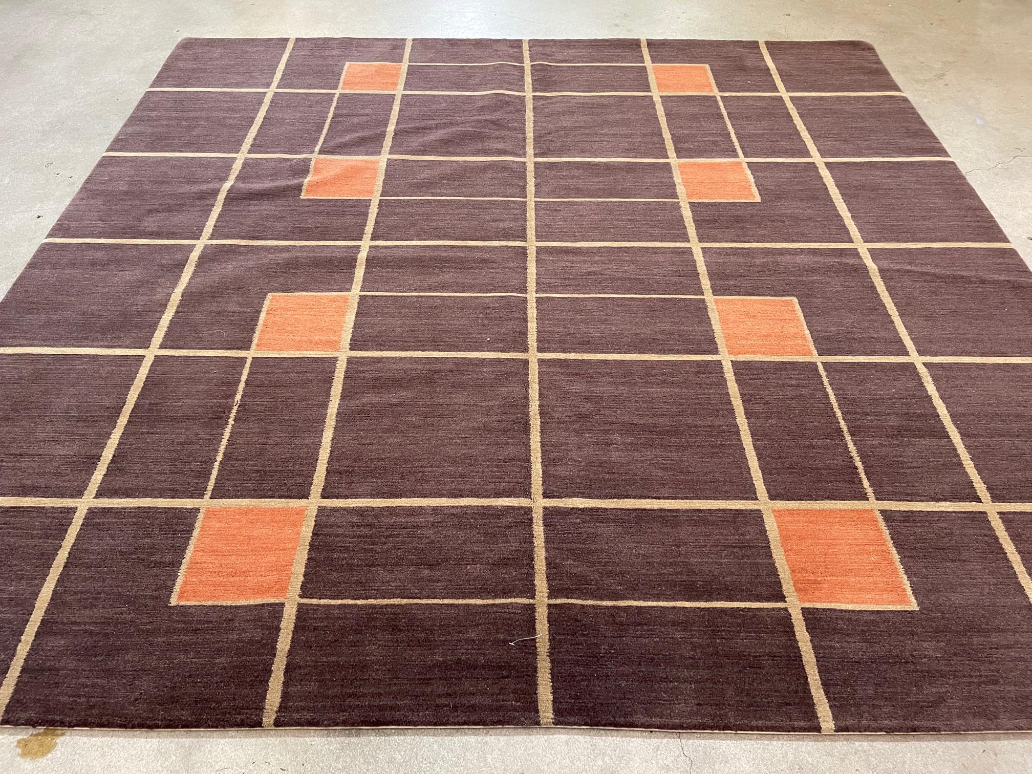 Geometric box pattern rug.

Colors: Teal, coral, dark brown.