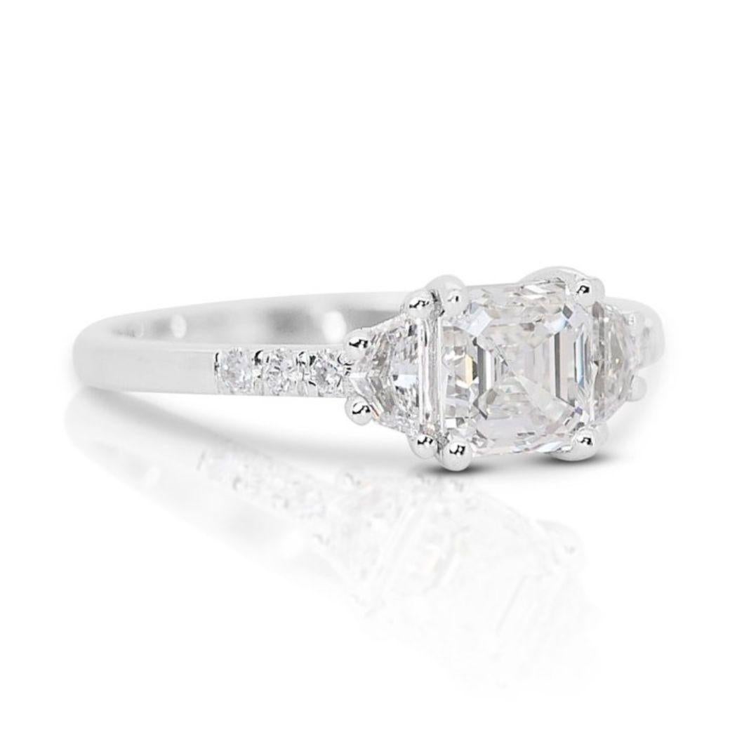 Embrace the captivating allure of this mesmerizing ring, featuring a stunning 1.01 carat Asscher cut diamond as its radiant centerpiece. Graced with an elegant G color, this diamond exudes subtle warmth and exceptional brilliance. The coveted VVS2