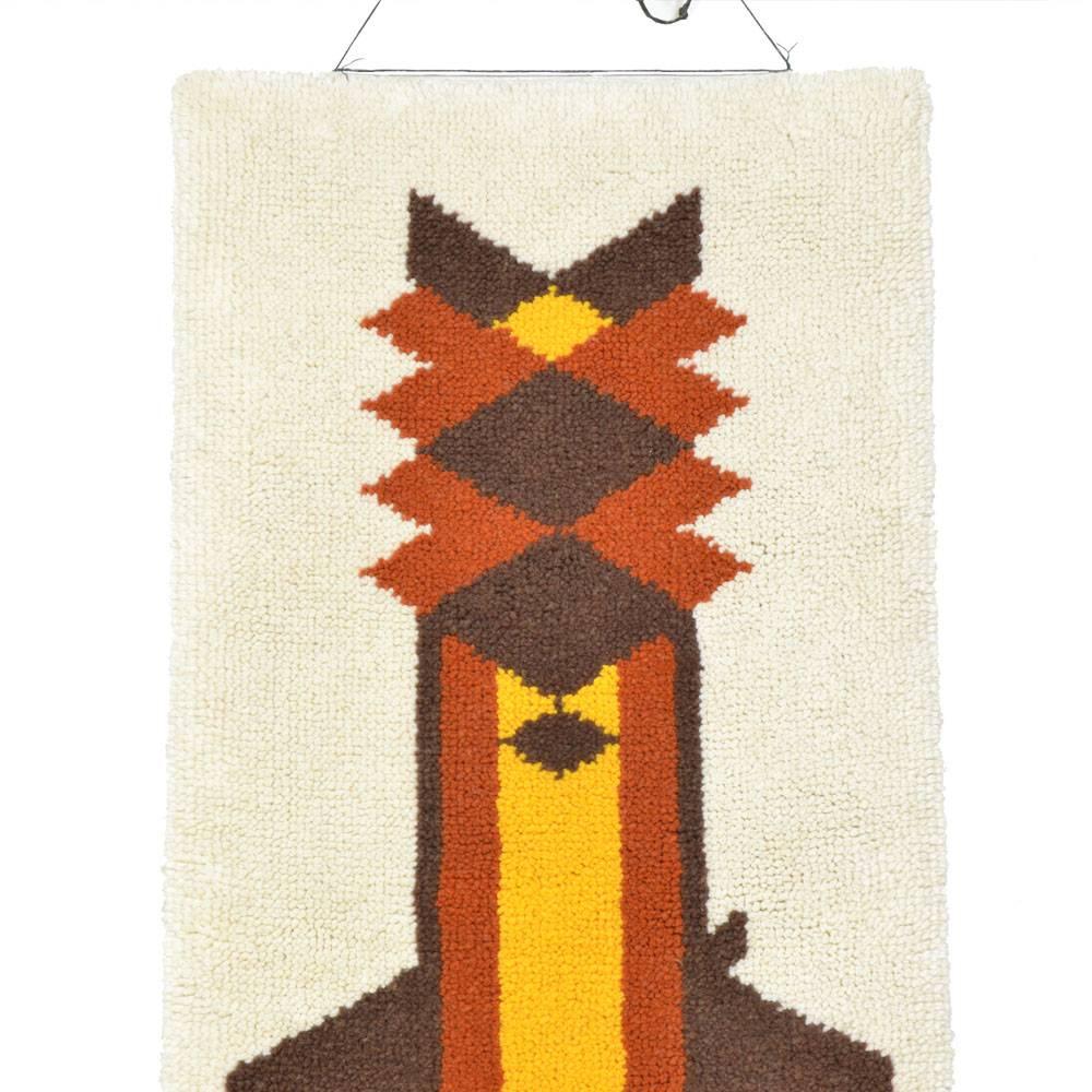 This handmade wall-rug with a geometric cat design was produced in Czechoslovakia during the 1970s. It has been cleaned, and has new wooden ribbons on the back for hanging.