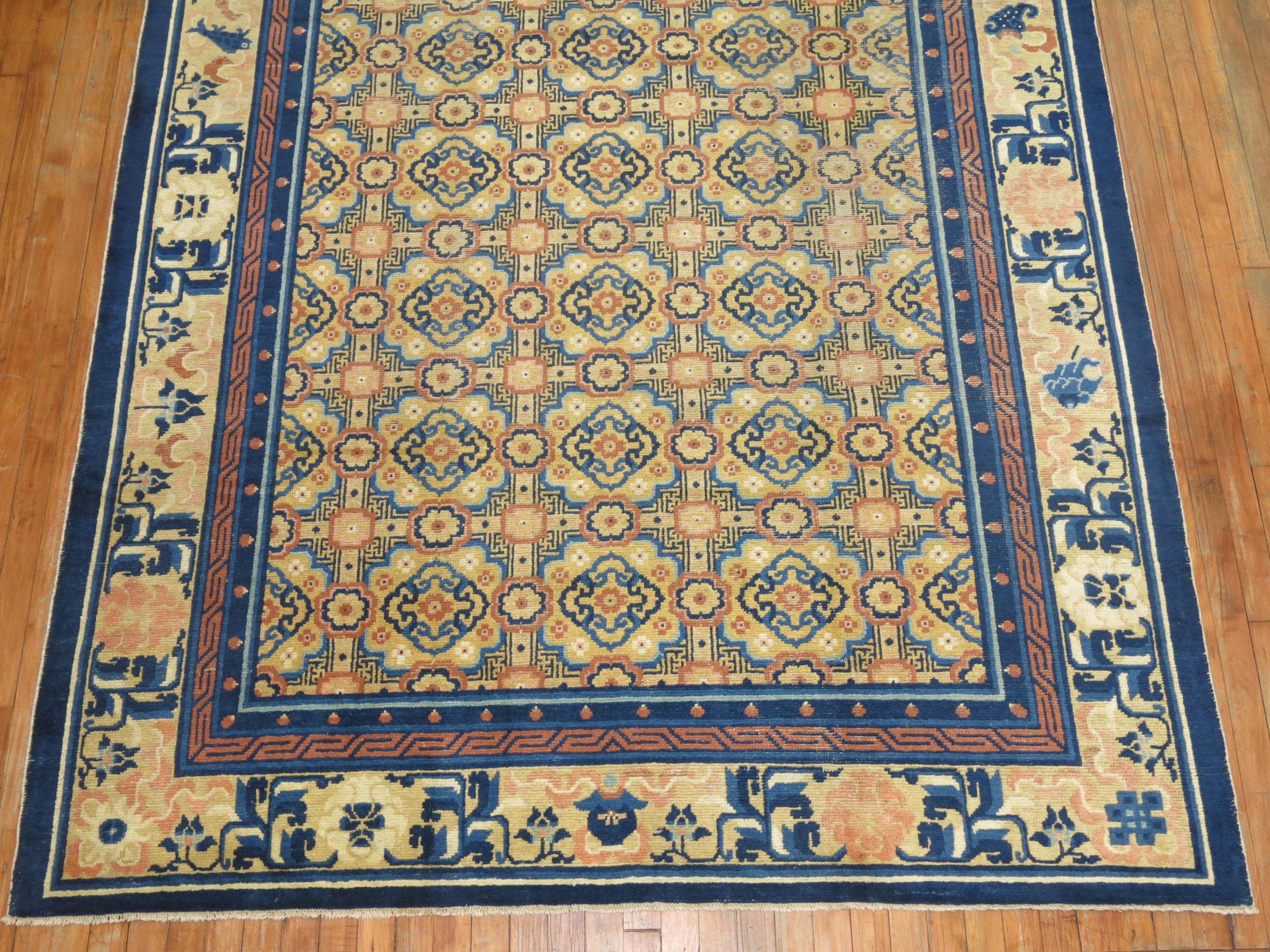 A charming early 20th century Chinese rug with an all over geometric motif in peach, beige, various shades of blue

Measures: 6'4'' x 811''.