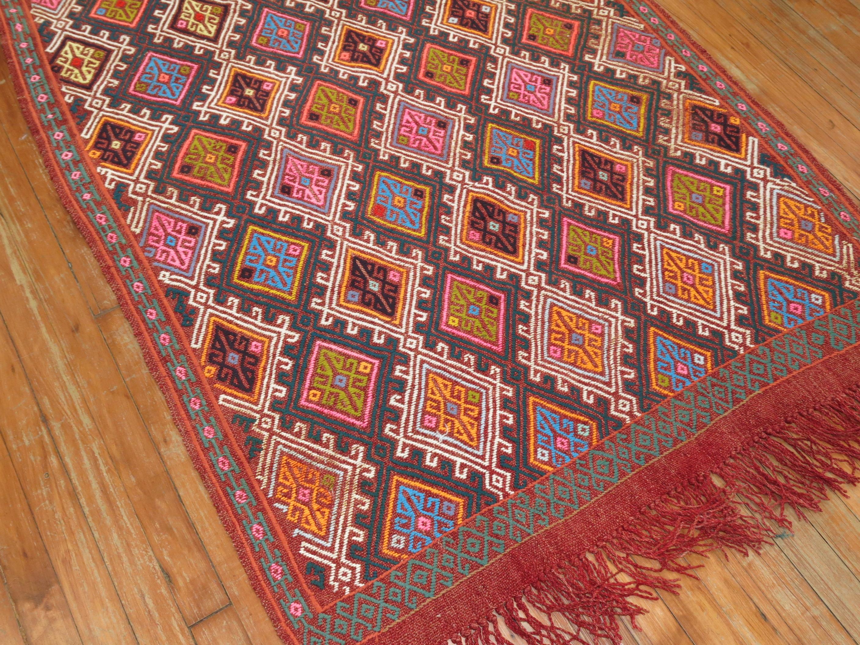 Colorful midcentury Turkish Jajim. Dominant Accents in bright pink, orange, electric blue

Measures: 3'8” x 6'9”

With the Jijim weaving technique, different colored threads are applied between the weft and warp threads, on the reverse of the