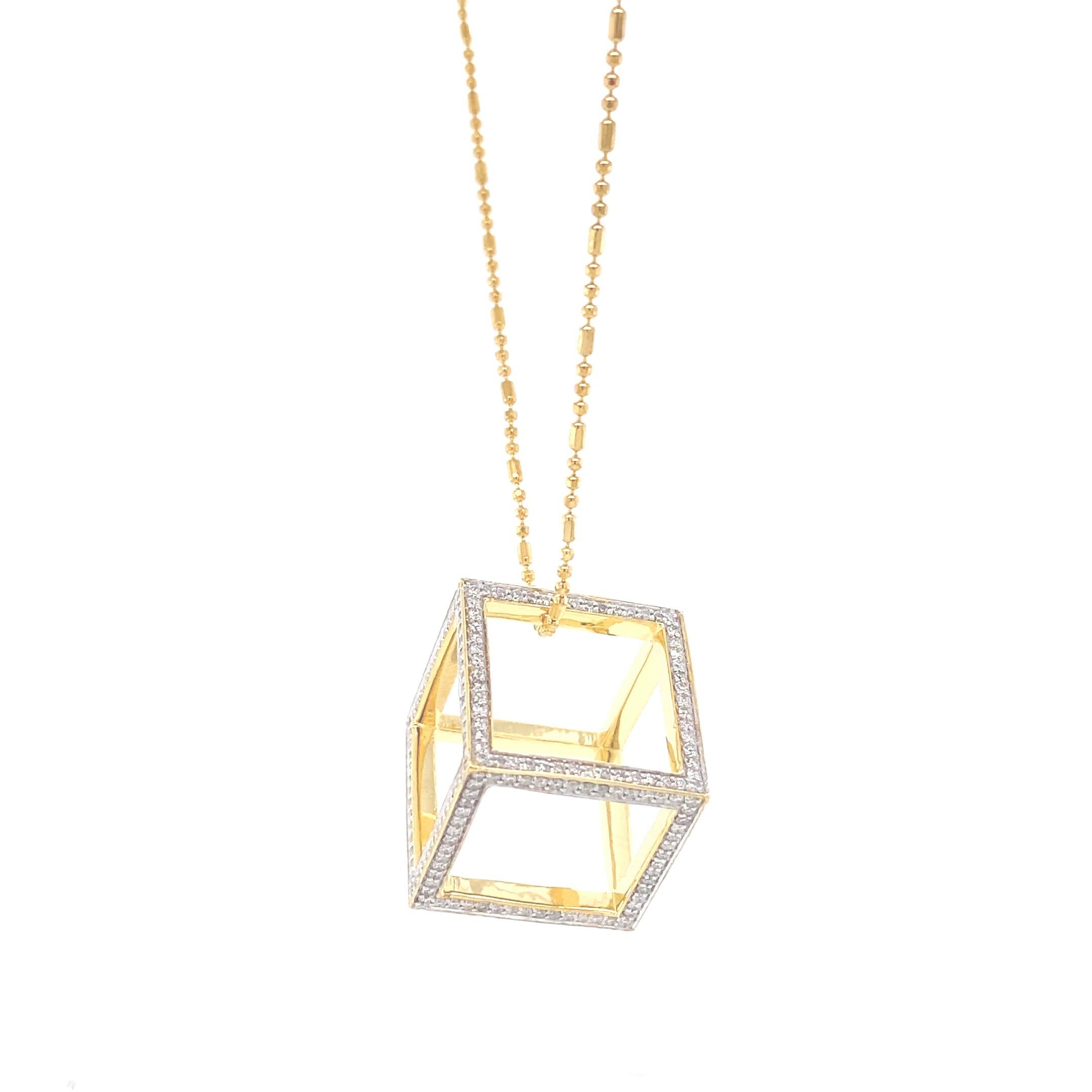 Presenting a masterfully crafted piece of artistry, features a captivating geometric pendant that exudes modern elegance. The luxurious pendant boasts a sleek gold finish, forming an open cube shape that makes a bold statement. Adorning the edges of