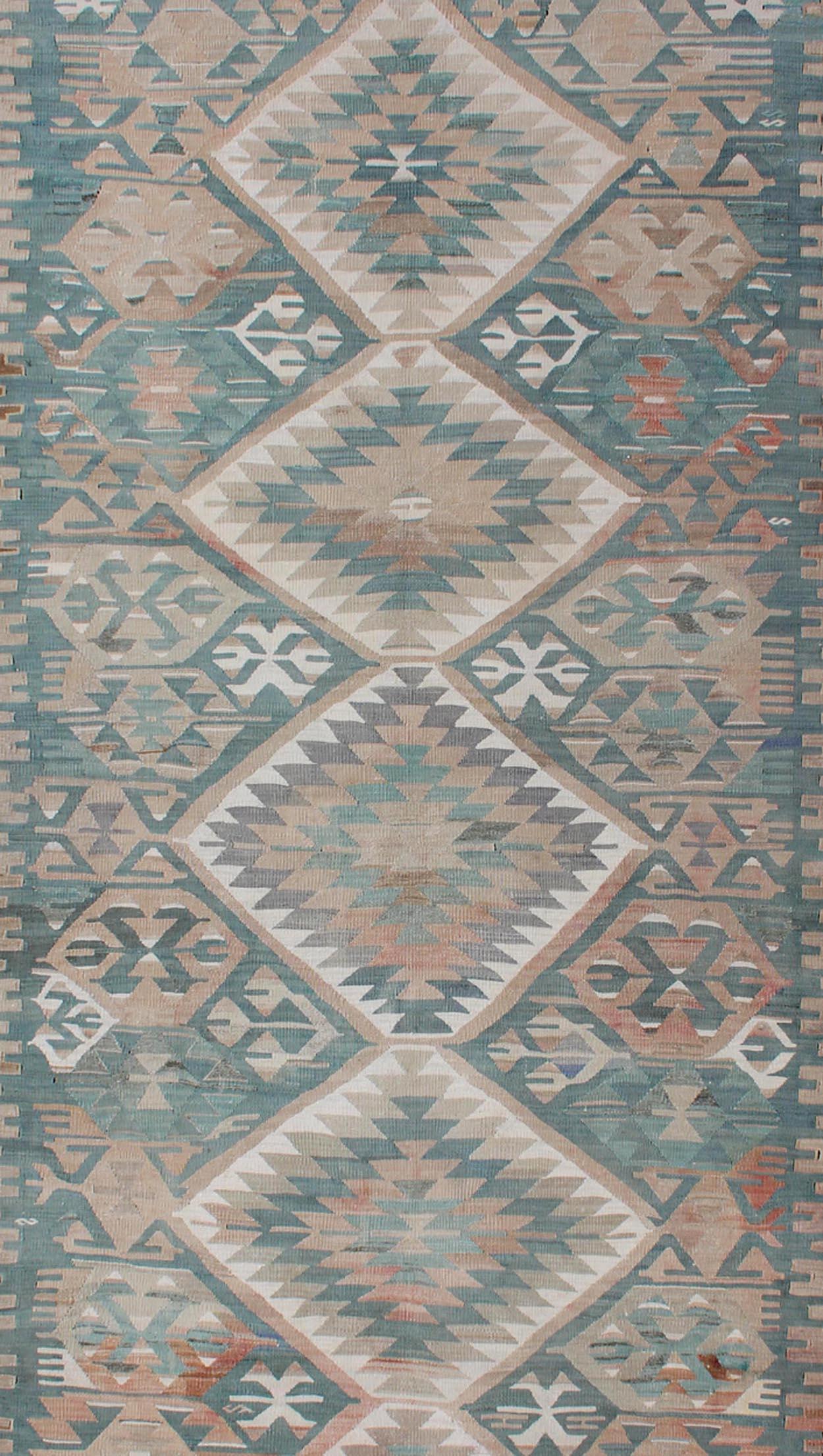 Geometric design vintage Kilim rug from Turkey in light teal and tan, light green neutral tones, rug EN-179073, country of origin / type: Turkey / Kilim, circa 1950.

Featuring a beautiful geometric design rendered in various color tones, this