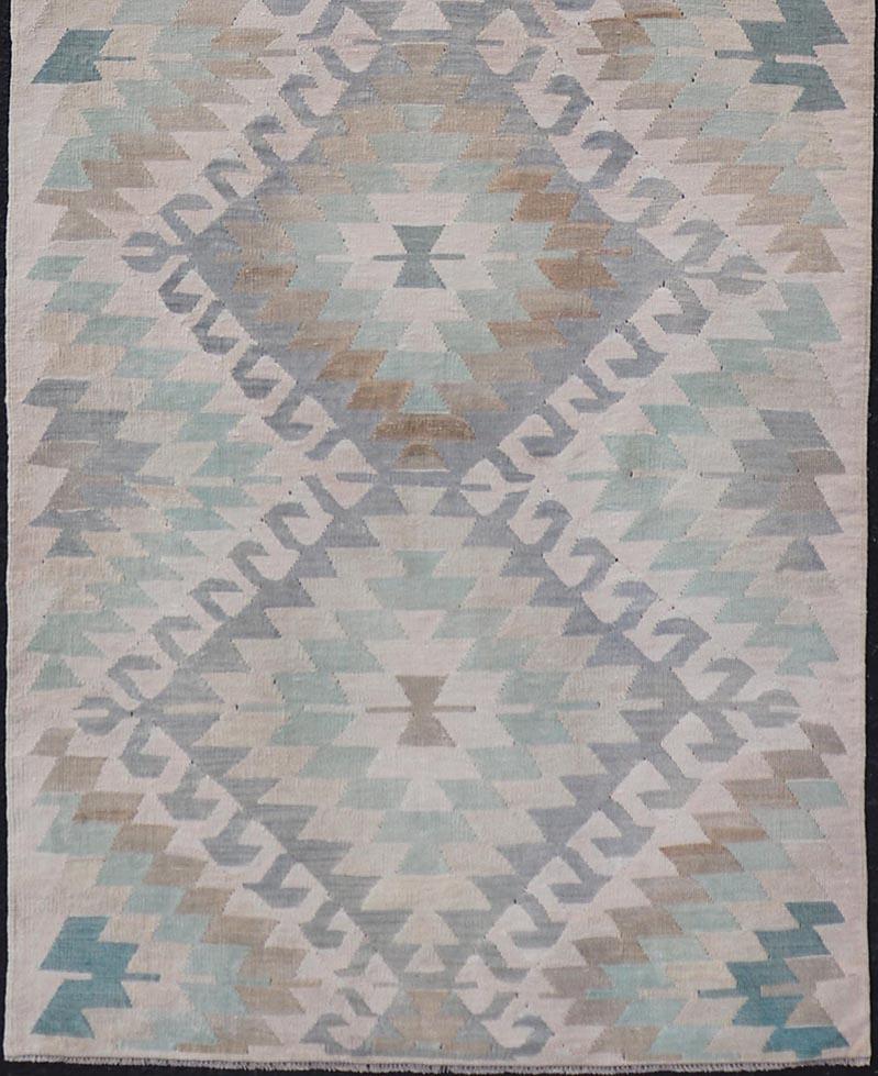 Measures: 3'3 x 9'9 

This vintage Turkish flat weave Kilim has a softened, almost pastel palette of peach, blue, teal, gray and brown. The design is a unique tribal diamond pattern reaching across the entirety of the field. 

Country of Origin: