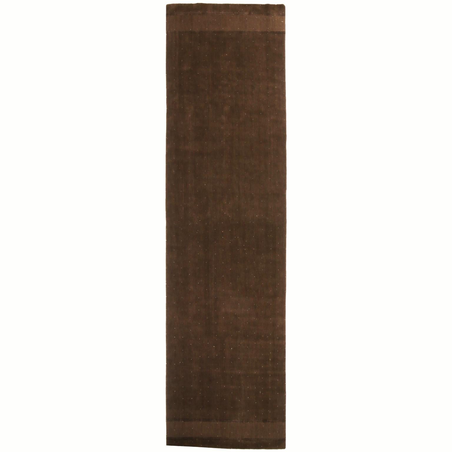 Hand knotted with high quality wool in Nepal, this geometric wool runner enjoys a tasteful oak and copper brown abrash background with finely woven white dot patterns throughout an all-over field design.
 