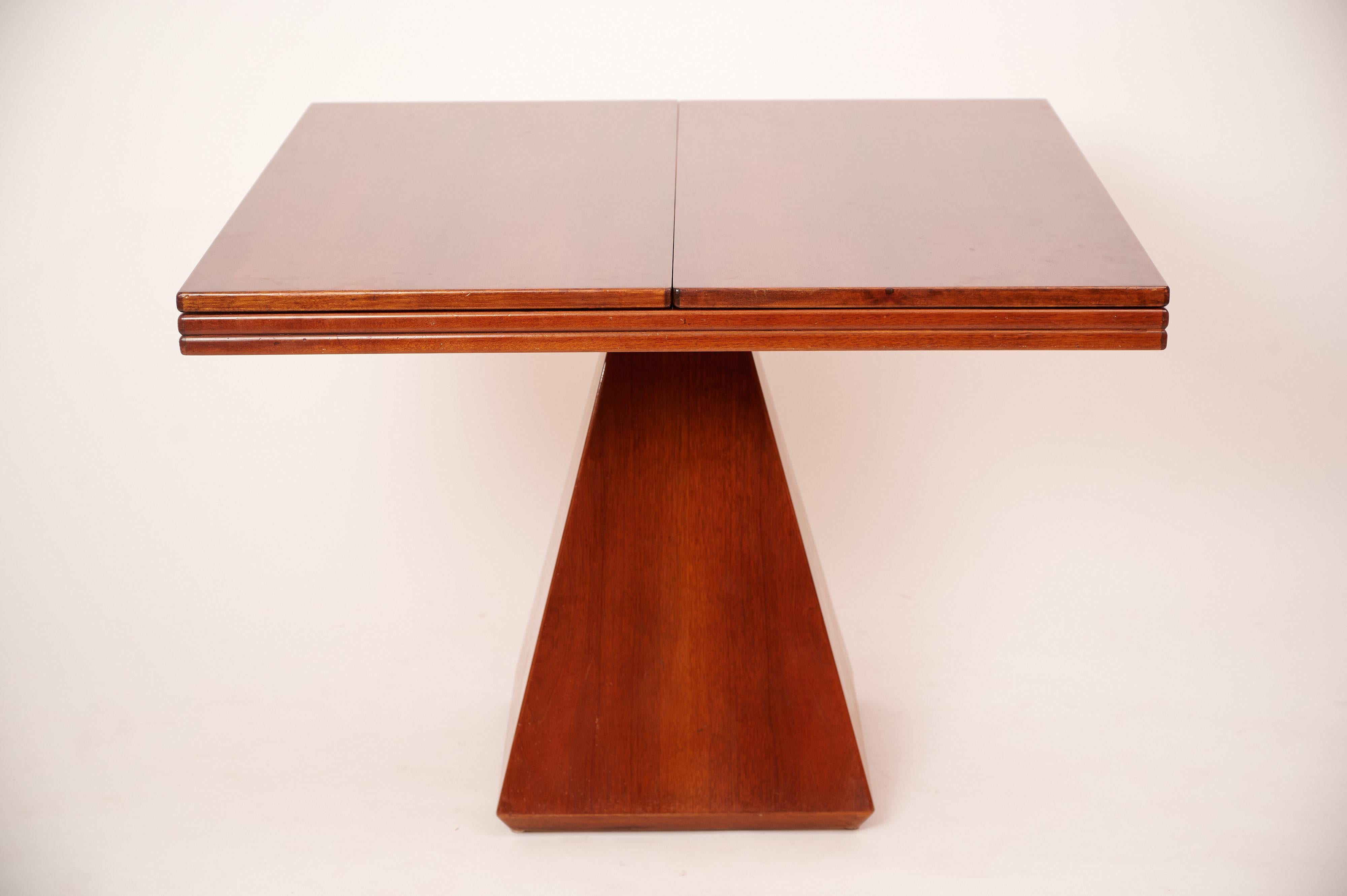 Geometric expanding table by Vittorio Introini. Italy c1968

A square based pyramid which holds a square table top which opens out into a rectangle. Perfectly balanced on a metal 'cross' which invisibly fits into the table top. The base is