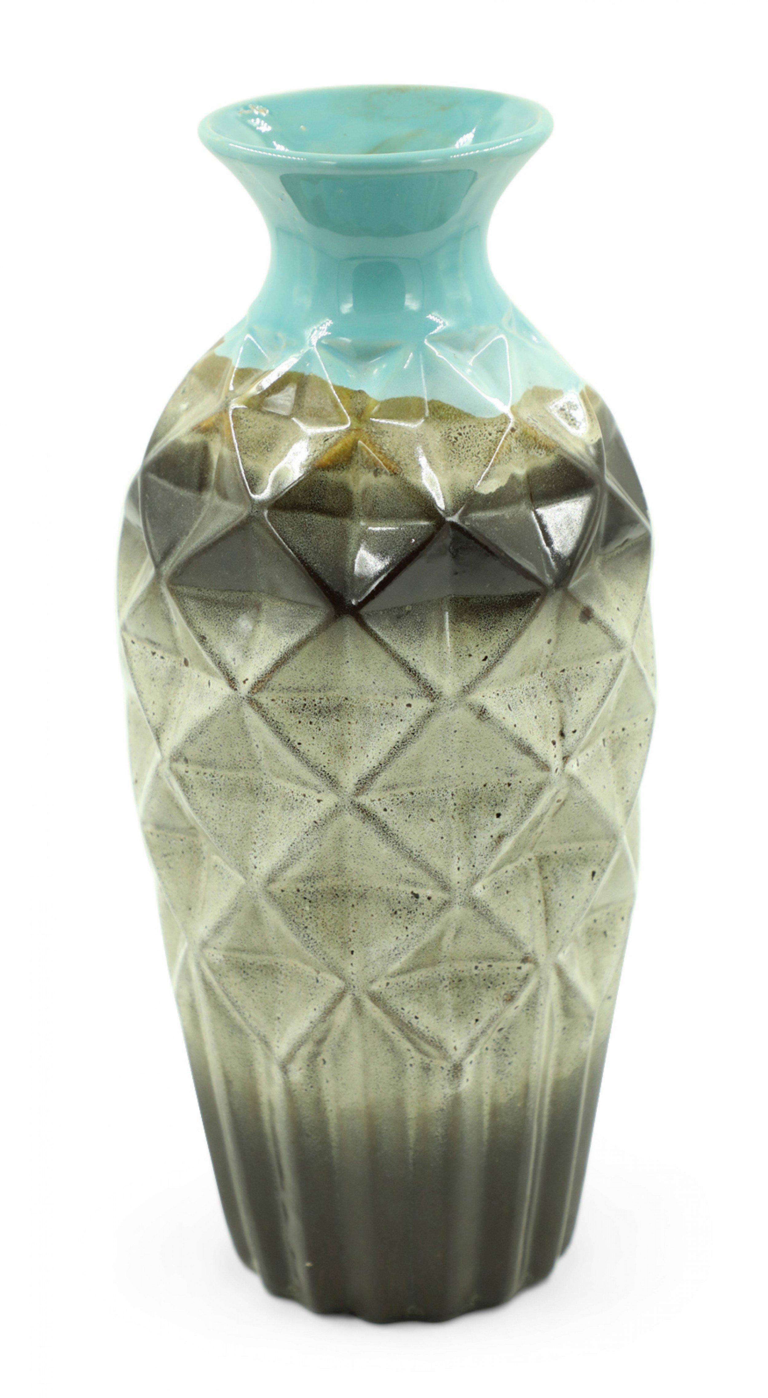 Contemporary blue, brown and beige glazed ceramic vase with a faceted geometric urn-shaped body, ribbed base, and fluted opening.
    