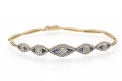 Geometric gold bracelet with diamonds and sapphires.