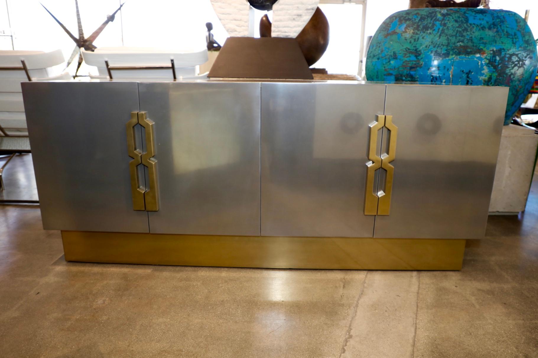 Our originals credenza designed and created by Marco Antonio. This credenza is coated in stainless and brass. One shelf in each side. The credenza is well made but has minor imperfections as it is handmade.