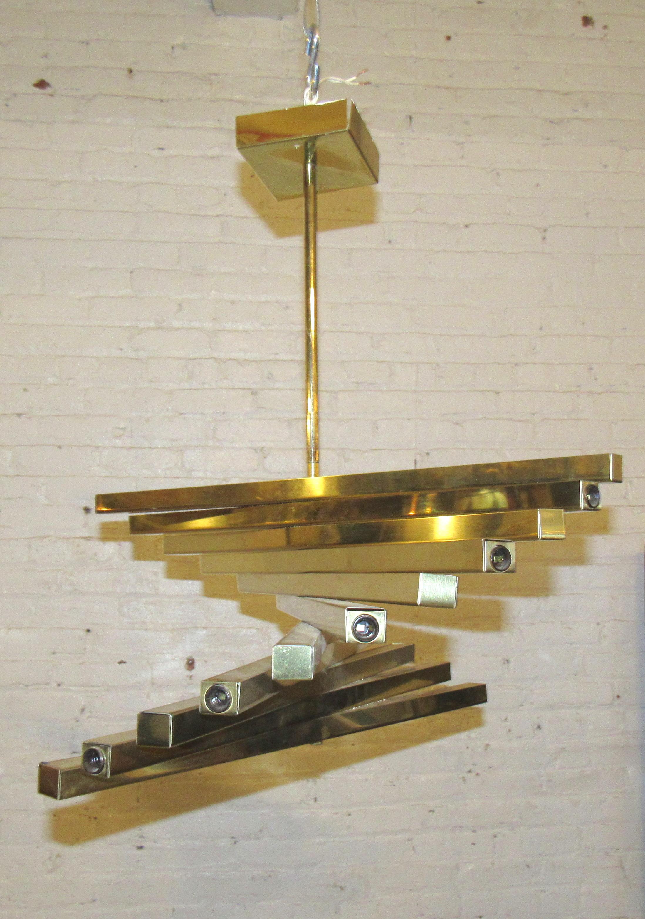 A vintage hanging pendant that combines geometric forms with stunning brass, this piece adds bold midcentury style to any space.

(Please confirm item location - NY or NJ - with dealer).

  
