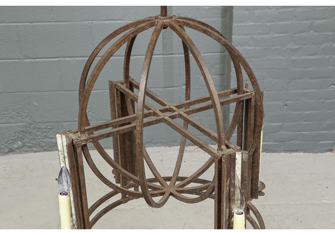 With a bold elemental and geometric form and having good weight and great style. Lighting is supplied by four wax clad chandelier bulb candles in lantern fittings. Ceiling canopy is included.

Dimensions: 27” diameter by 31” high. 

Condition: