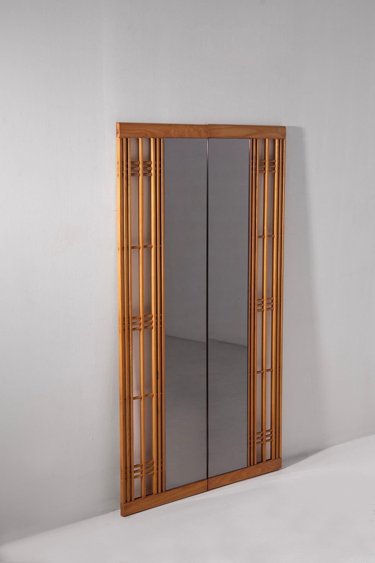 Sculptural Italian Design with Architectural Grid Motifs and Artisanal Joinery
This rare and eccentric Italian wall mirror from the 1970s is a striking statement piece that blends architectural geometry with refined craftsmanship. Clearly influenced