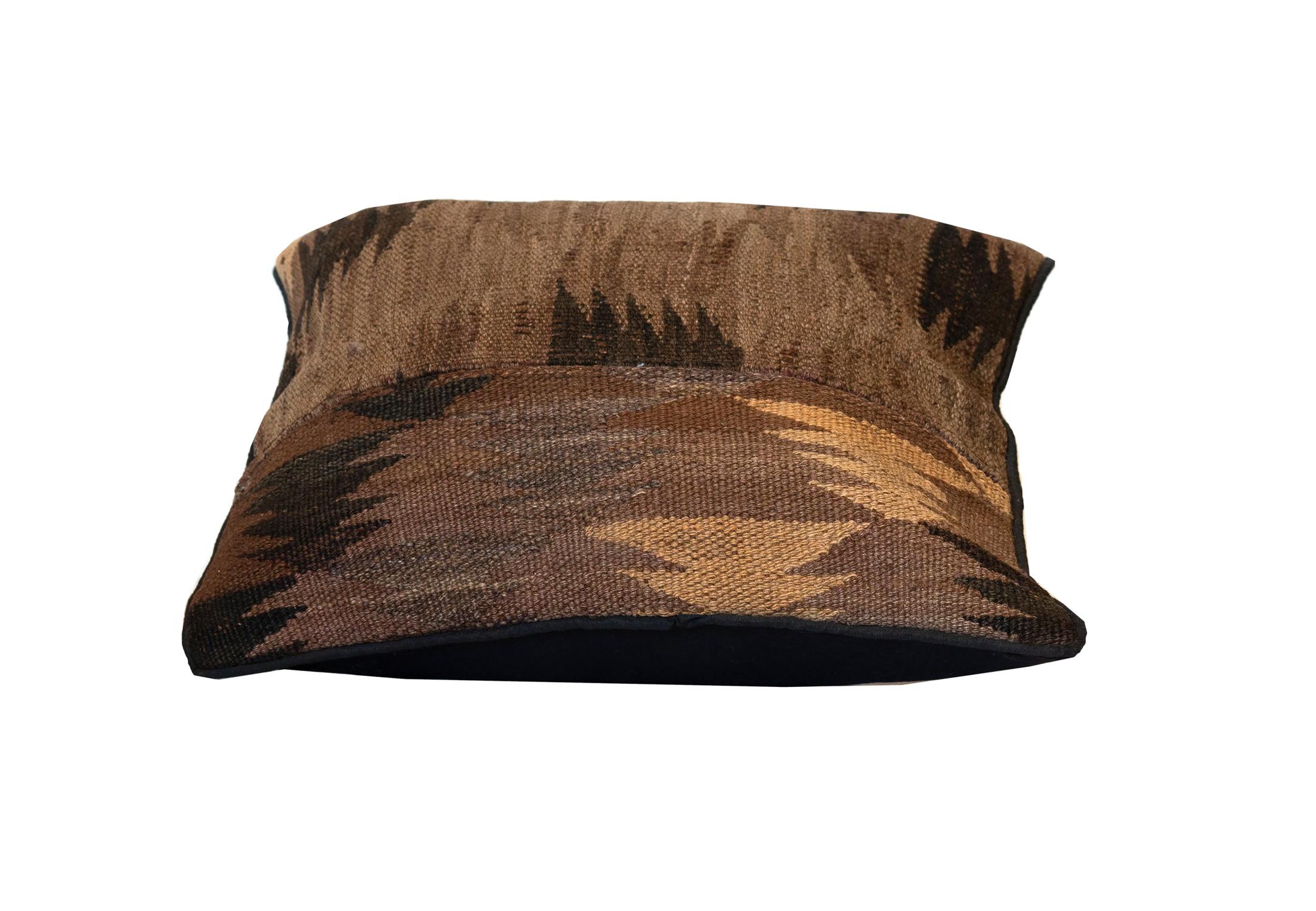 This brown vintage cushion has been woven by hand using traditional Kilim weaving techniques with hand-spun wool. We are featuring an abstract geometric design woven in a brown and cream colour pallet. This piece is sure to make the perfect