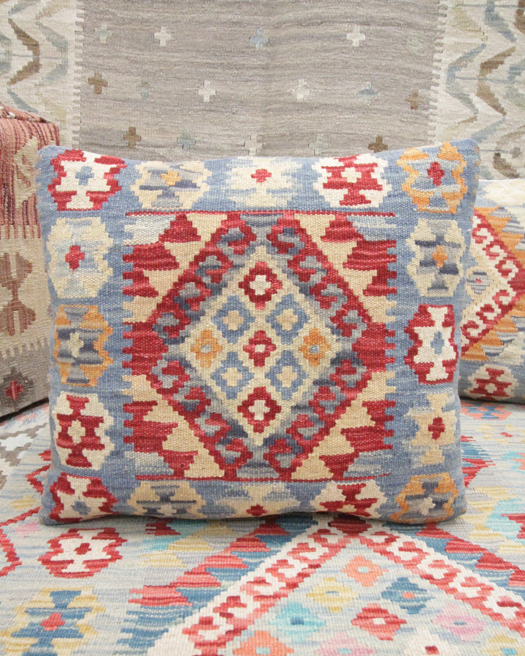 This new traditional kilim cushion cover is a handwoven piece constructed in the early 21st century. The design has been delicately woven by hand and features a symmetrical geometric pattern that is sure to stand out on any sofa or armchair! This