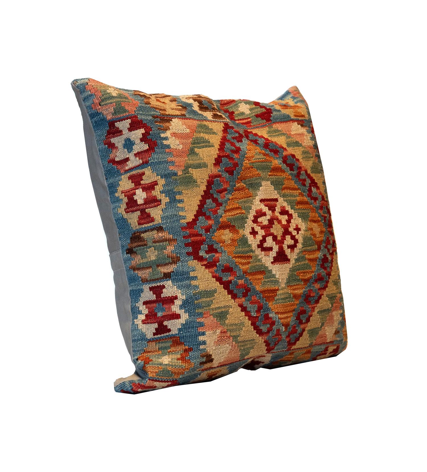This fantastic cushion has been woven by hand using traditional kilim weaving techniques with hand-spun wool. They featured asymmetrical geometric patterns woven in beautiful rustic colours, including olive green, cream, rust orange, red and blue.