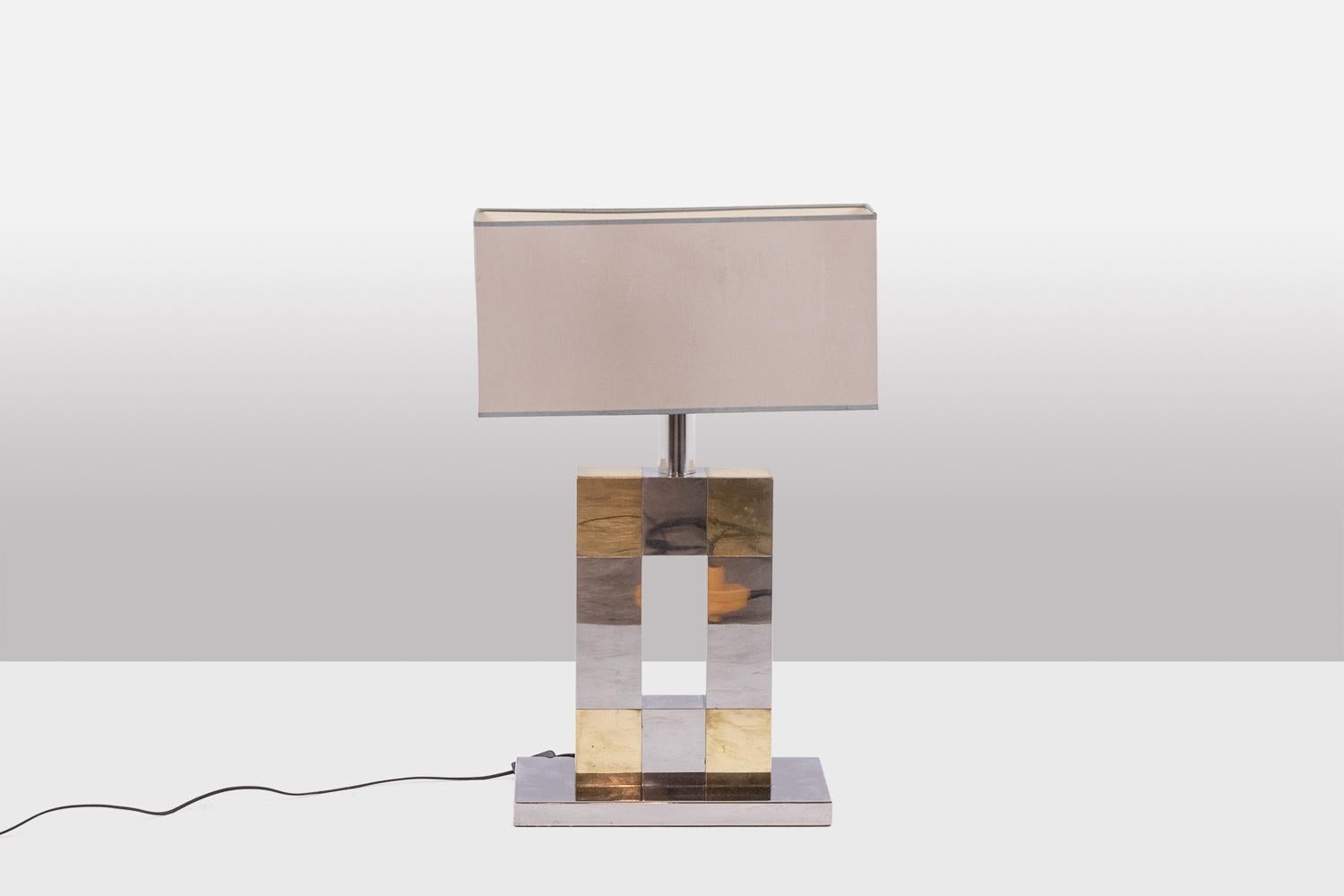 Geometric lamp in silver and gold metal, openwork in the center, with its rectangular base. Rectangular shaped lampshade.

Italian work realized in the 1970s.

Dimensions: H 77 x W 40,5 x D 24 cm

Reference: LS5792258U