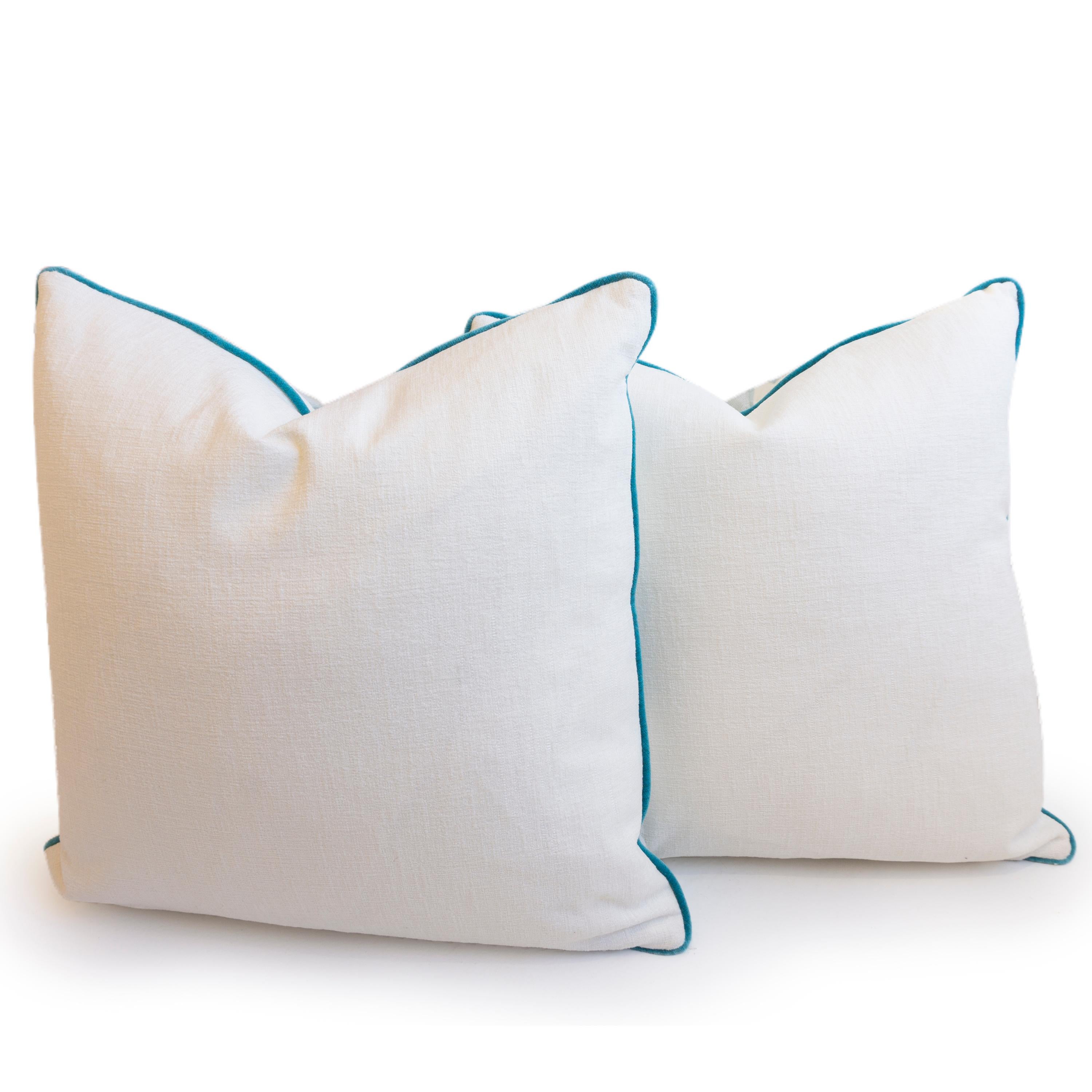 A pair of pillows hand sewn in a blue geometric patterned linen and blue velvet trim. 

Measurements: 21” x 21”.