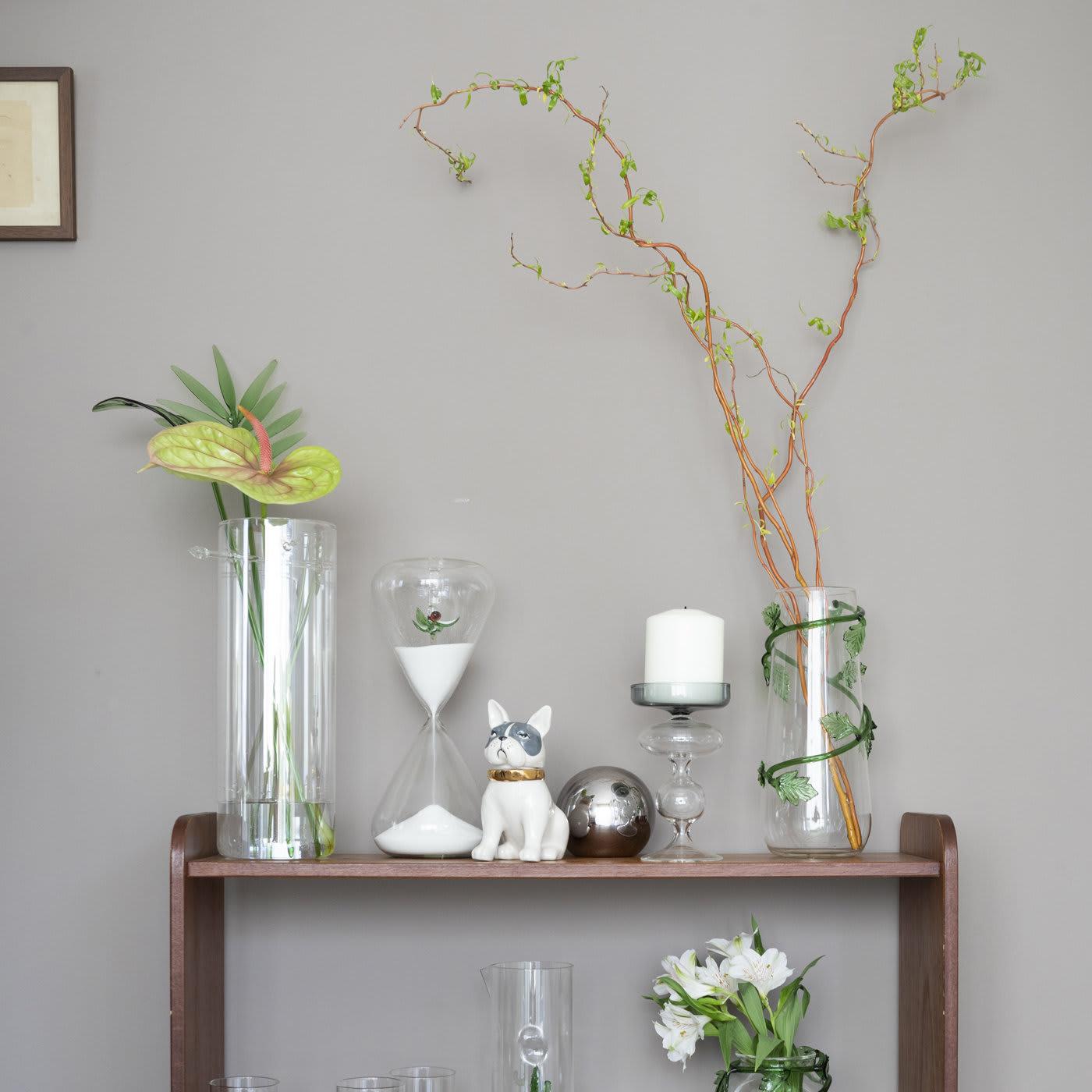 Handcrafted in Venice, this candle holder is made of transparent glass curving mellifluously in fluid forms, while the broad socket takes a dark smoky hue.