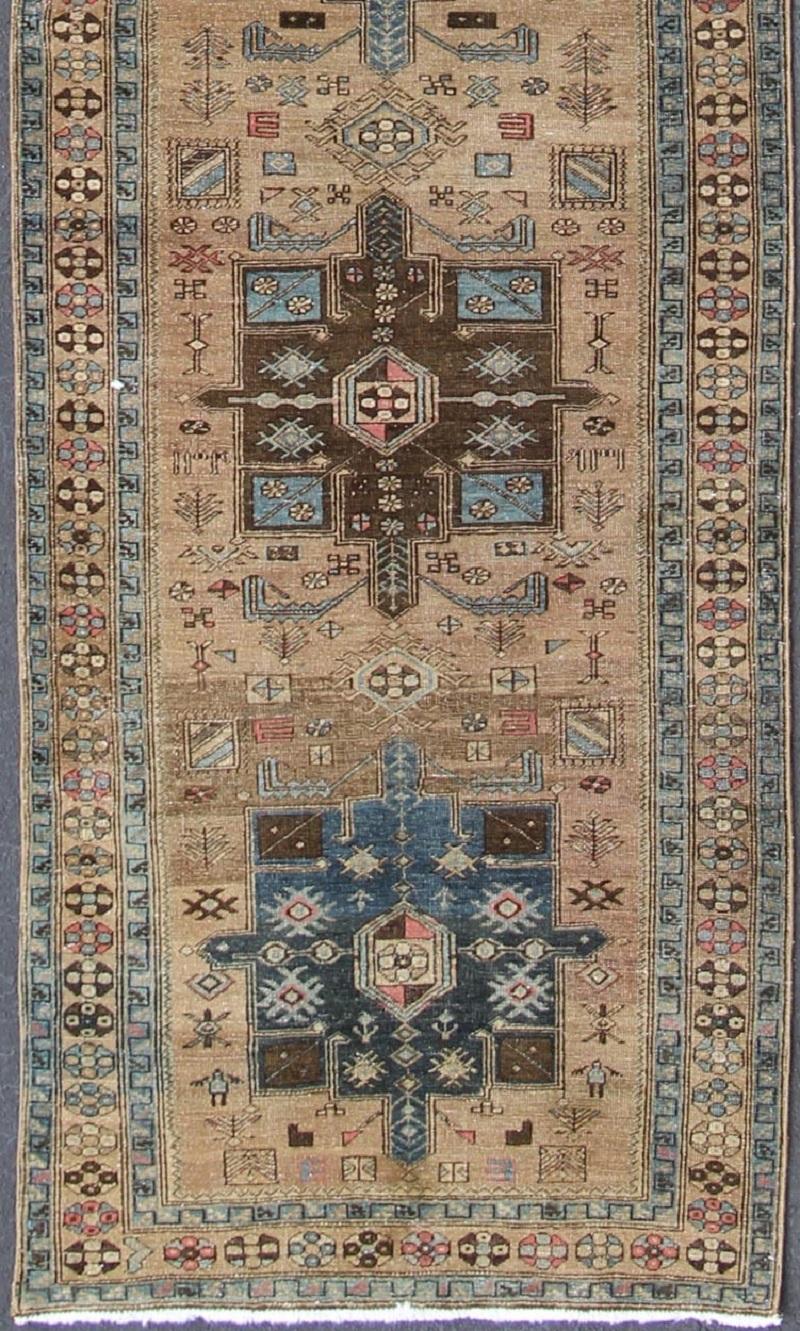 Geometric Medallion Heriz long antique runner in tan, brown and blue, rug h-405-11, country of origin / type: Iran / Heriz, circa 1930.

Geometric Medallion Heriz long antique runner in tan, brown & blue
This magnificent antique Persian Heriz