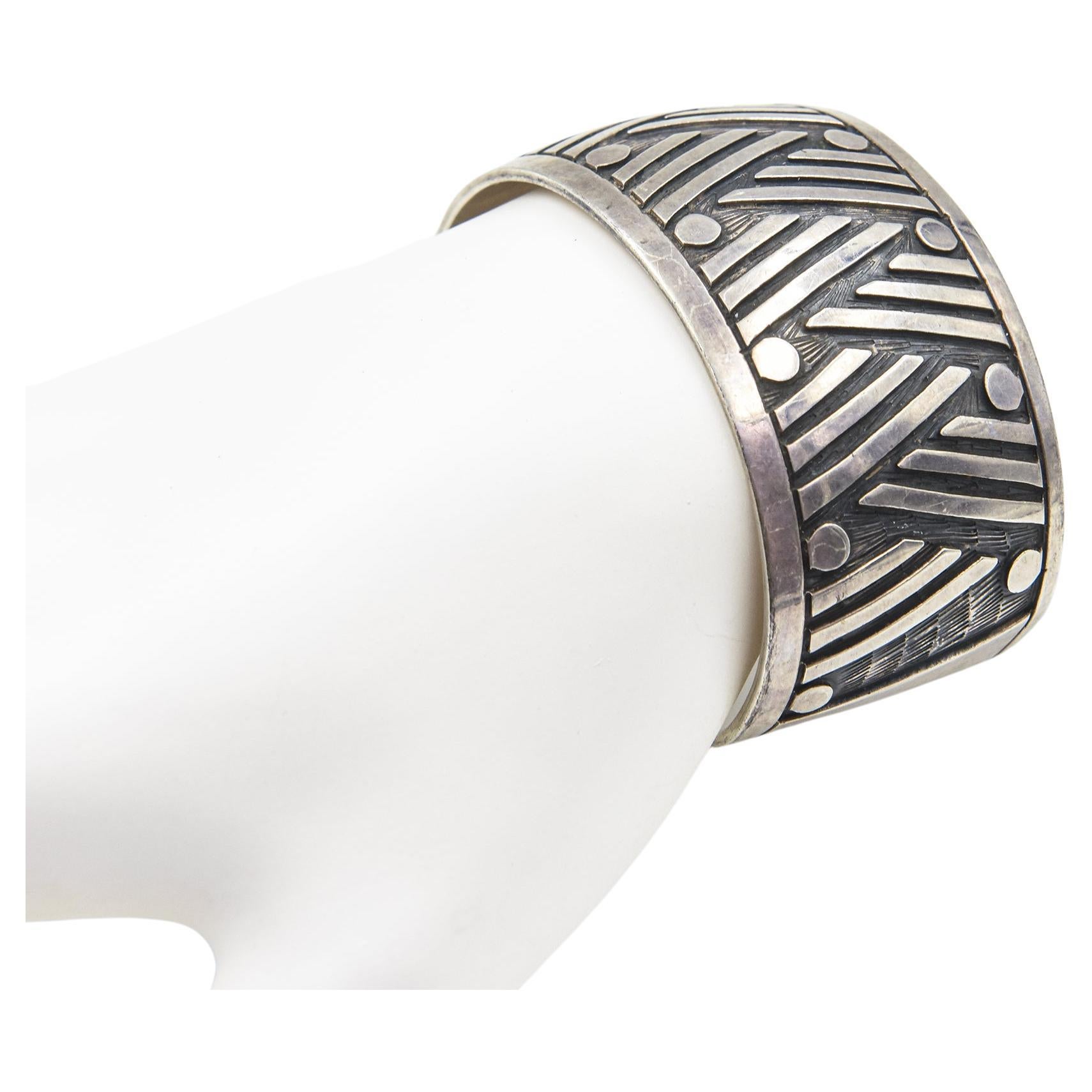 Highly stylized geometric design Mexican sterling silver cuff bracelet.
Interior circumference measures 5 3/4