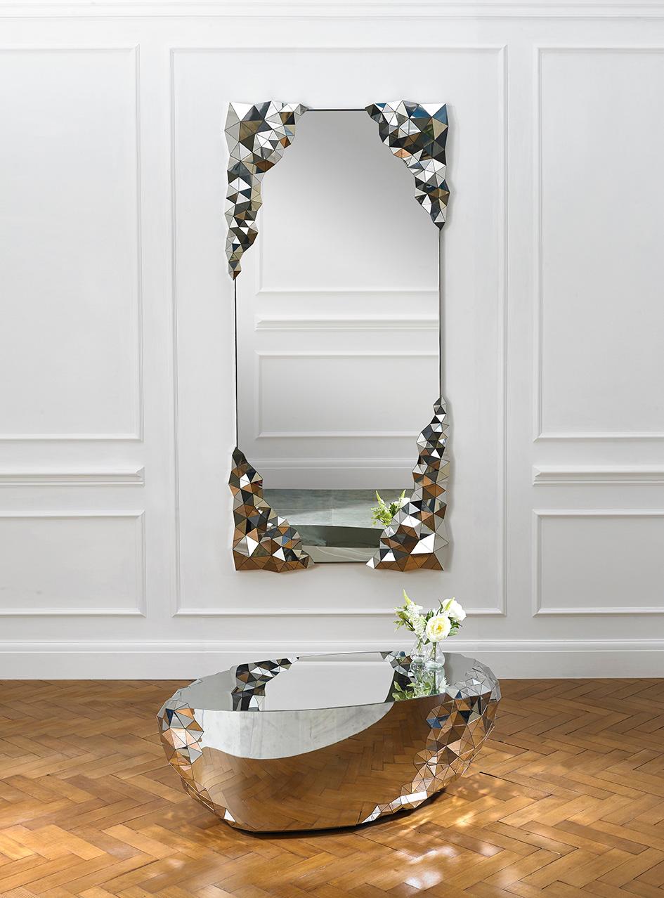 Part of the award winning stellar collection - the rectangular stellar mirror is inspired by the precious qualities of naturally forming amethyst geodes and machine cut diamonds. The large expansive center of the mirror is in stark contrast to the