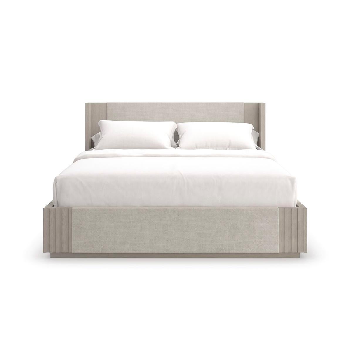 Inviting and impossibly elegant in a crisp linen fabric, the king bed sets a tranquil tone in a monochromatic palette. Elevated on a discreet platform base, its simple yet stylish frame features slatted corner details, meticulously crafted in oak