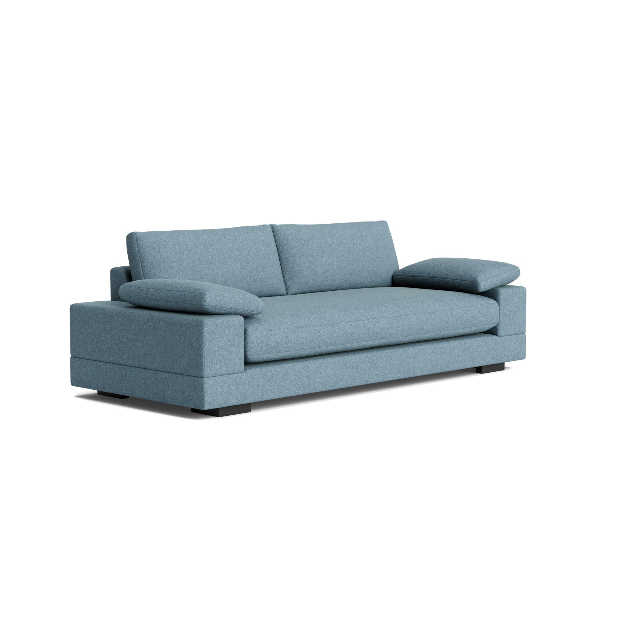 The Geometric Modern Sofa exudes understated elegance. Its extra-wide, rectilinear arms are adorned with relaxed throw pillows, all resting on a single, seamless bench seat—chic and effortlessly comfortable.
